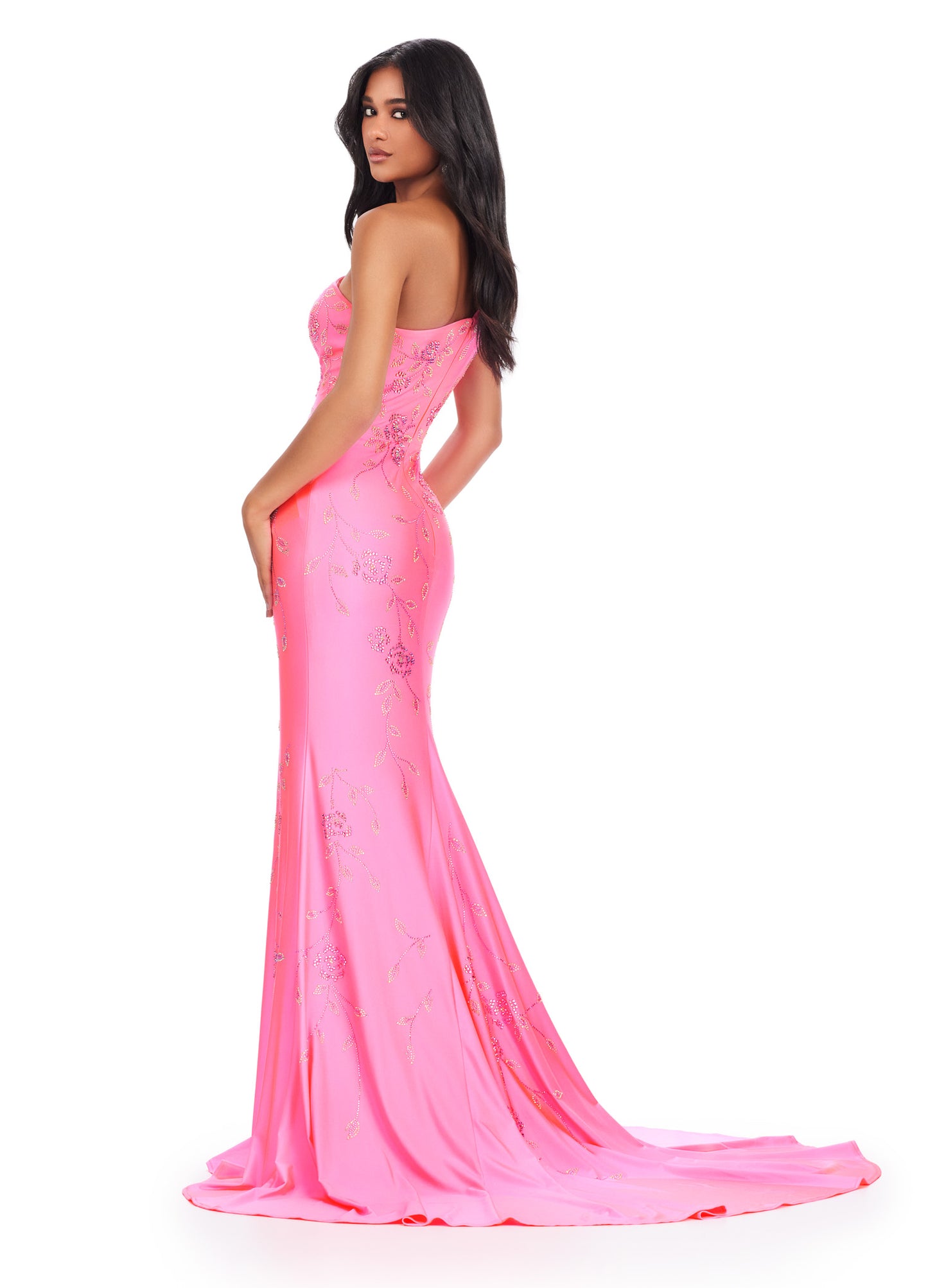 Make a stunning entrance in the Ashely Lauren 11525 Long Prom Dress. Featuring a one shoulder design and a press on floral bead pattern, this gown exudes sophistication and elegance. The jersey fabric offers a comfortable and flattering fit, perfect for any formal occasion. Make a statement in this pageant-worthy gown. This one shoulder jersey gown features a delicate multi-colored heat set stone floral bead pattern that cascades down onto the skirt.