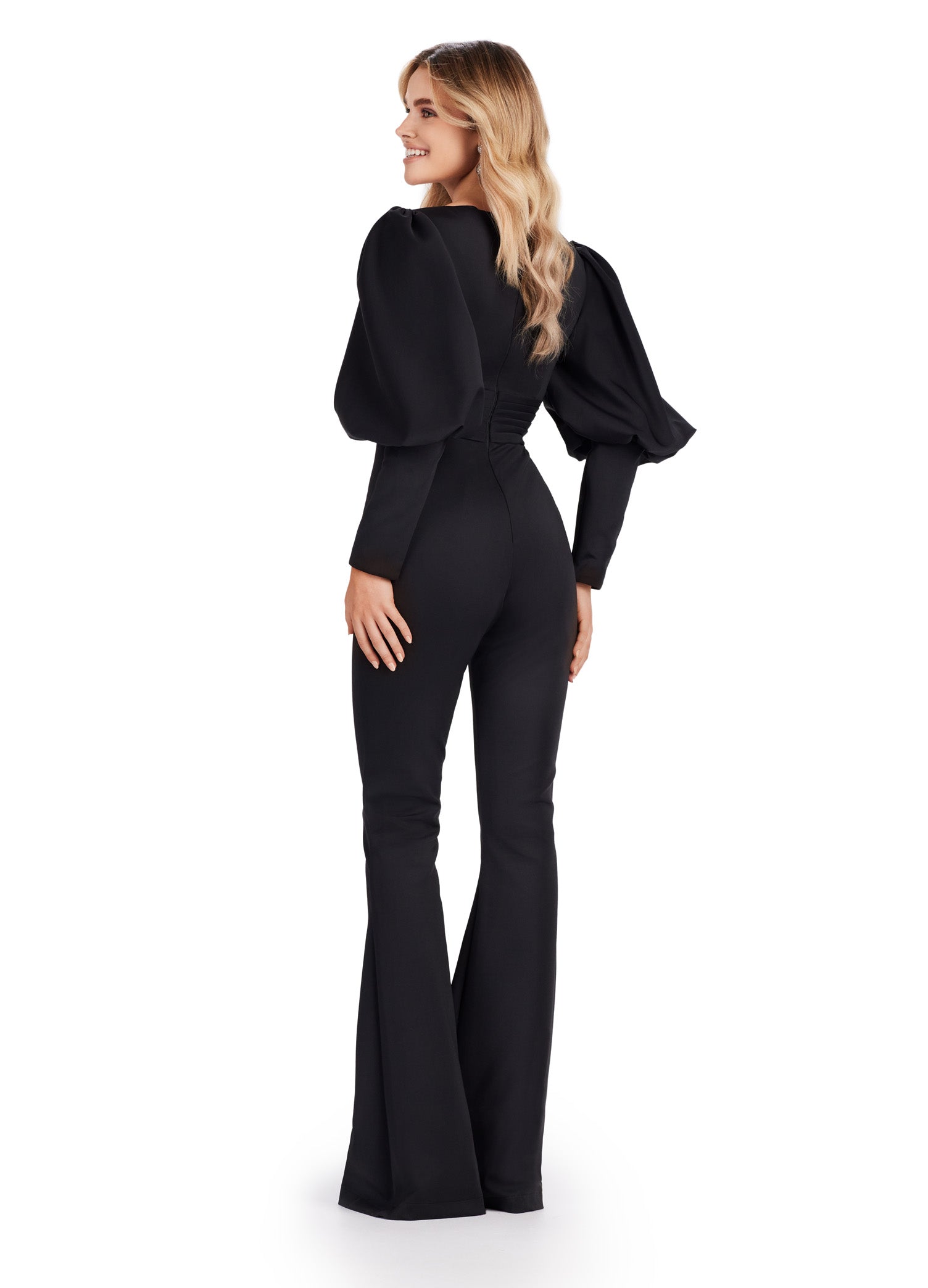 As a leading expert in formal attire, Ashley Lauren presents the 11533 Prom V-Neck Scuba Jumpsuit with Bishop Sleeves. Made from high-quality scuba fabric, this jumpsuit features a flattering V-neckline and bishop sleeves for added elegance. Perfect for any formal event, this jumpsuit exudes sophistication and style. his striking scuba jumpsuit features a v-neckline and bishop sleeves.