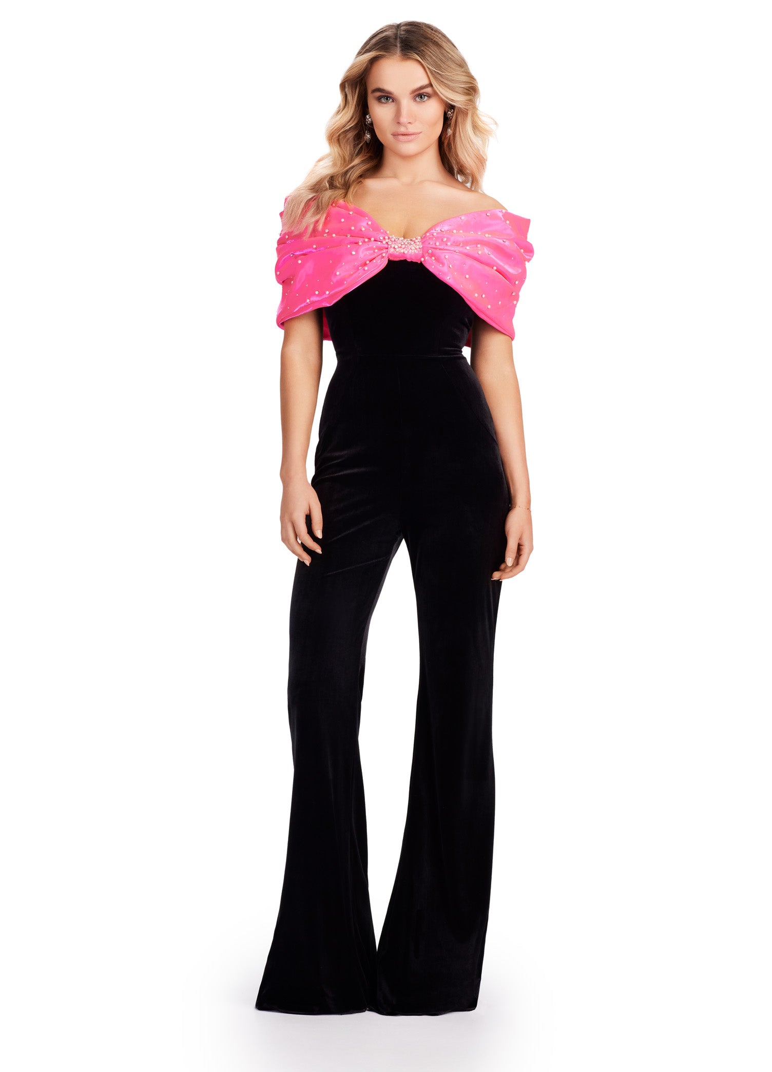 The Ashley Lauren 11535 Prom Jumpsuit combines luxurious velvet with an off-shoulder design for a sophisticated and stylish look. The oversized satin bow adds a touch of elegance, making it perfect for formal events. Its strapless design ensures comfort without sacrificing style. The jumpsuit of our dreams! This strapless velvet jumpsuit features a fabulous oversized satin bow. Perfect for your next event!
