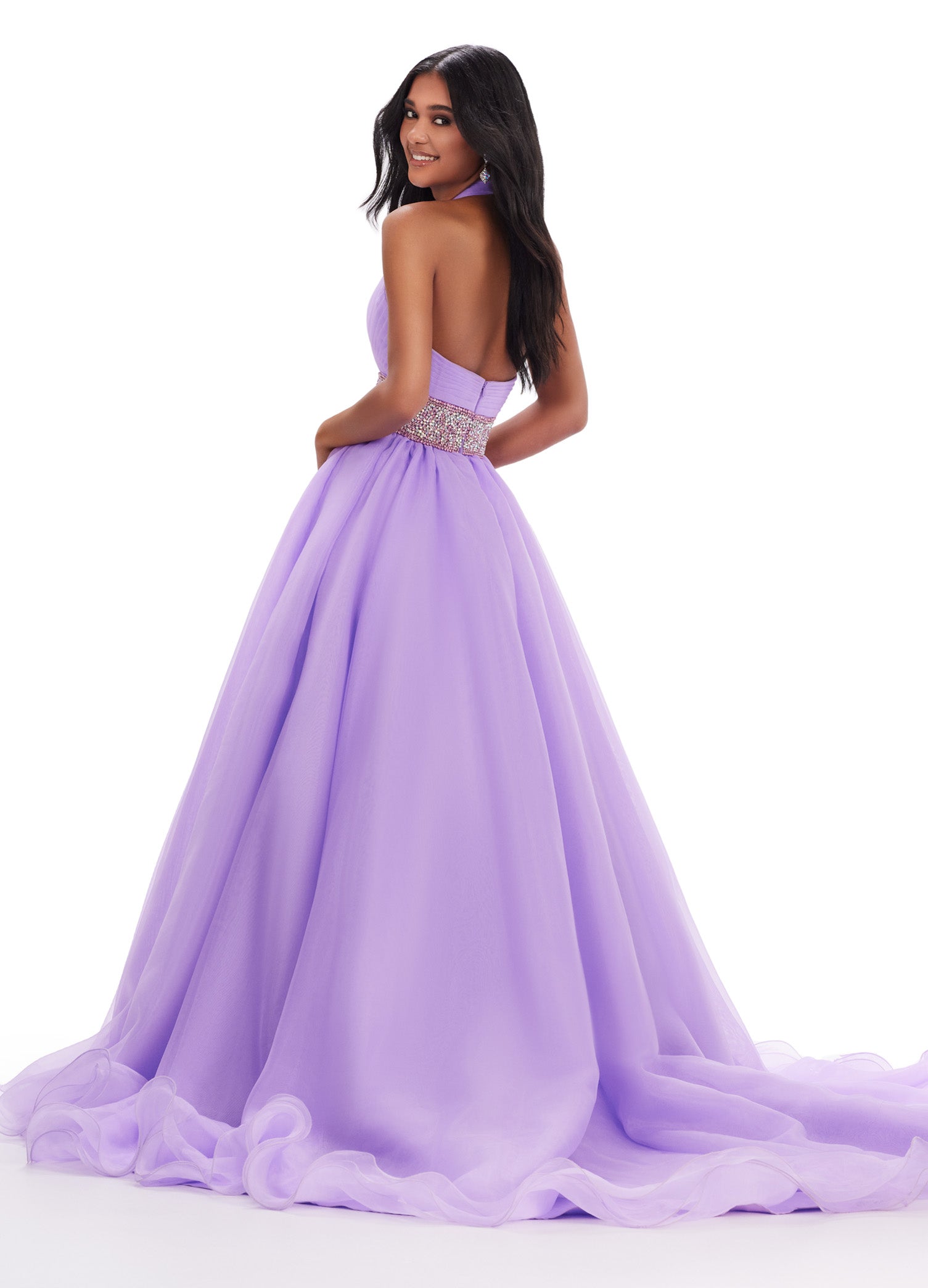 Expertly designed by Ashley Lauren, this formal pageant gown features a beautiful organza ball gown and a stunning beaded belt. Its delicate fabric and intricate details exude elegance, making it the perfect choice for any special occasion. Stand out and feel confident in this long prom dress. Turn heads in this v-neckline organza ball gown with wide fully encrusted crystal waistline. The look is complete with wire hem details.