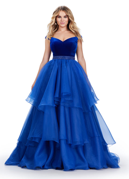 Stay on trend with this stunning Ashley Lauren prom dress. The off-shoulder design and organza ball gown create a classic silhouette, while the velvet bustier adds a touch of luxury. The beaded belt adds a flattering and stylish detail to this formal pageant gown. Elevate your prom look with this timeless and elegant dress. This striking off the shoulder ball gown features a velvet bodice with crystal trimmed waistline. The organza ruffle skirt completes the look.