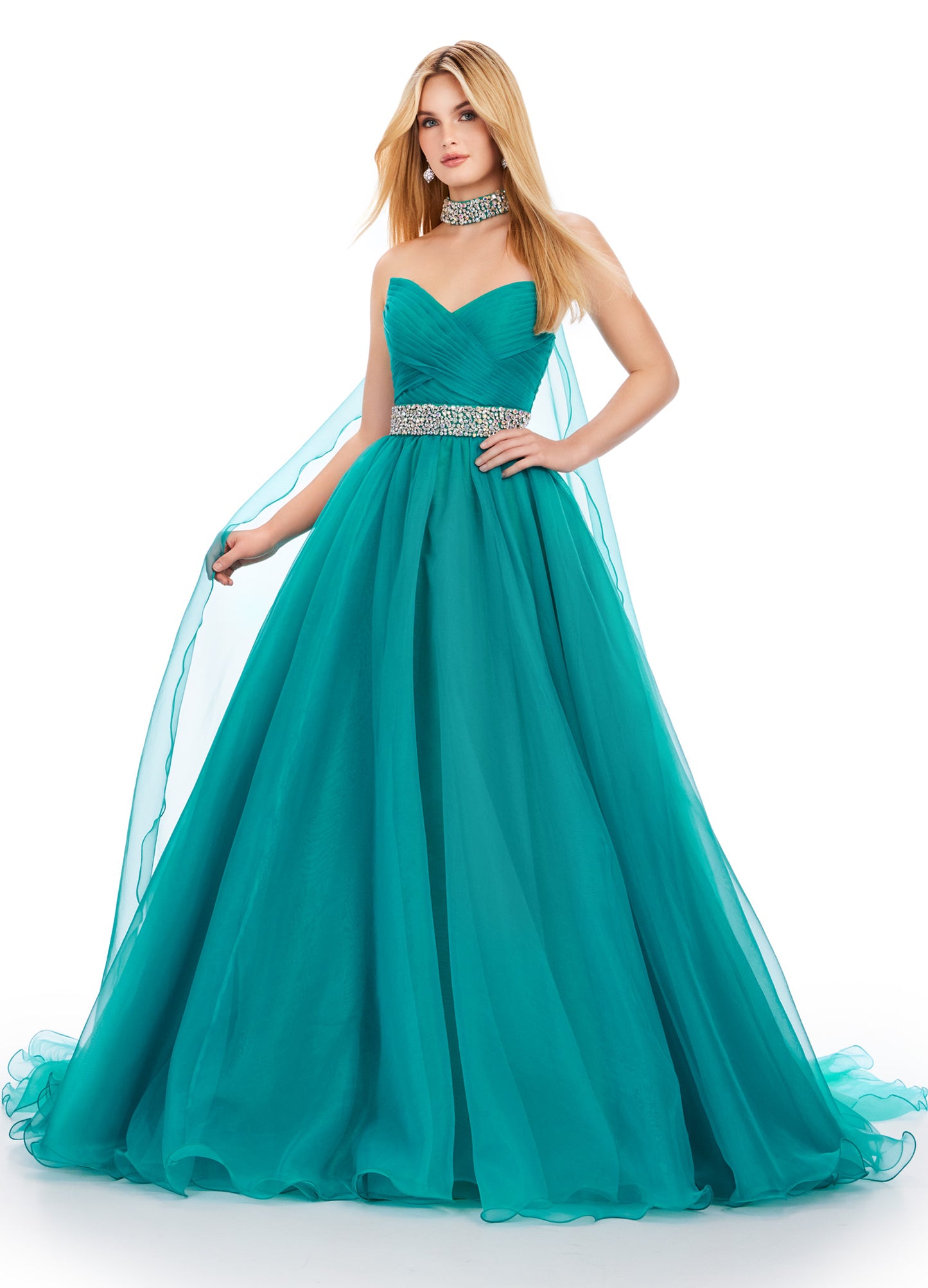 The Ashley Lauren 11565 Long Prom Dress is a stunning organza ball gown that features a beaded choker and a flowing cape, perfect for formal events or pageants. With its intricate beading and elegant design, this dress will make you feel like a true princess. A dress sure to make you feel like a queen. This strapless organza ball gown features a beaded waist band. The look is finished with a beaded choker and organza cape.
