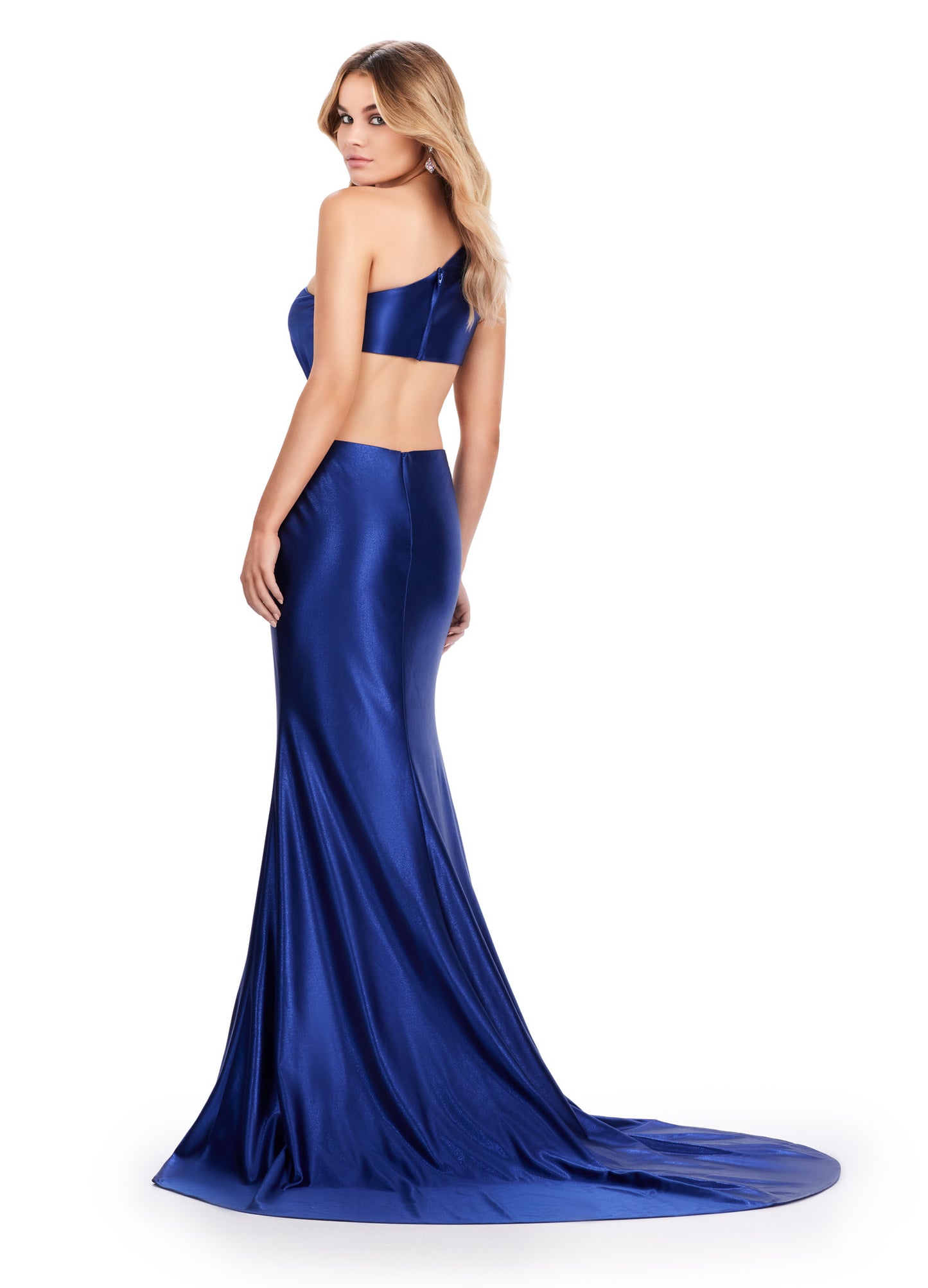 xpertly designed by Ashely Lauren, this elegant 11577 Long Prom Dress features a fitted one shoulder satin gown with stylish cut outs and intricate beading. Perfect for formal events and pageants, it offers a sophisticated and flattering silhouette for any occasion. Elevate your style with this stunning gown. This simplistic, yet elegant one shoulder satin gown features an elegantly draped bodice leading to a side cut out. The look is accented by a beaded brooch.