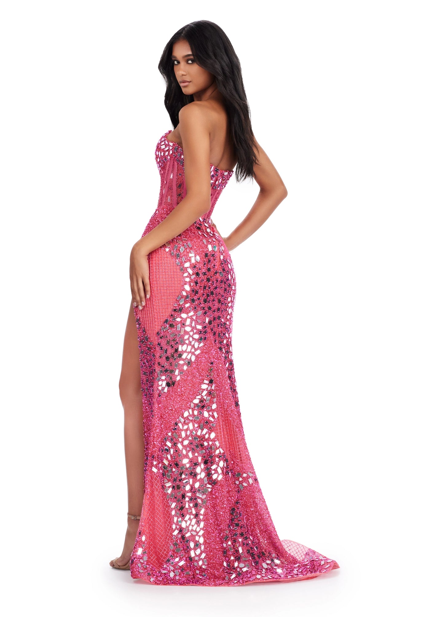 The Ashley Lauren 11599 prom dress is an eye-catching statement piece. Crafted from luxurious glistening cut glass fabric, this gown features an alluring corset-style bodice and a show-stopping thigh-high slit. The gleaming beaded embellishments add a touch of sparkle that is sure to make you shine