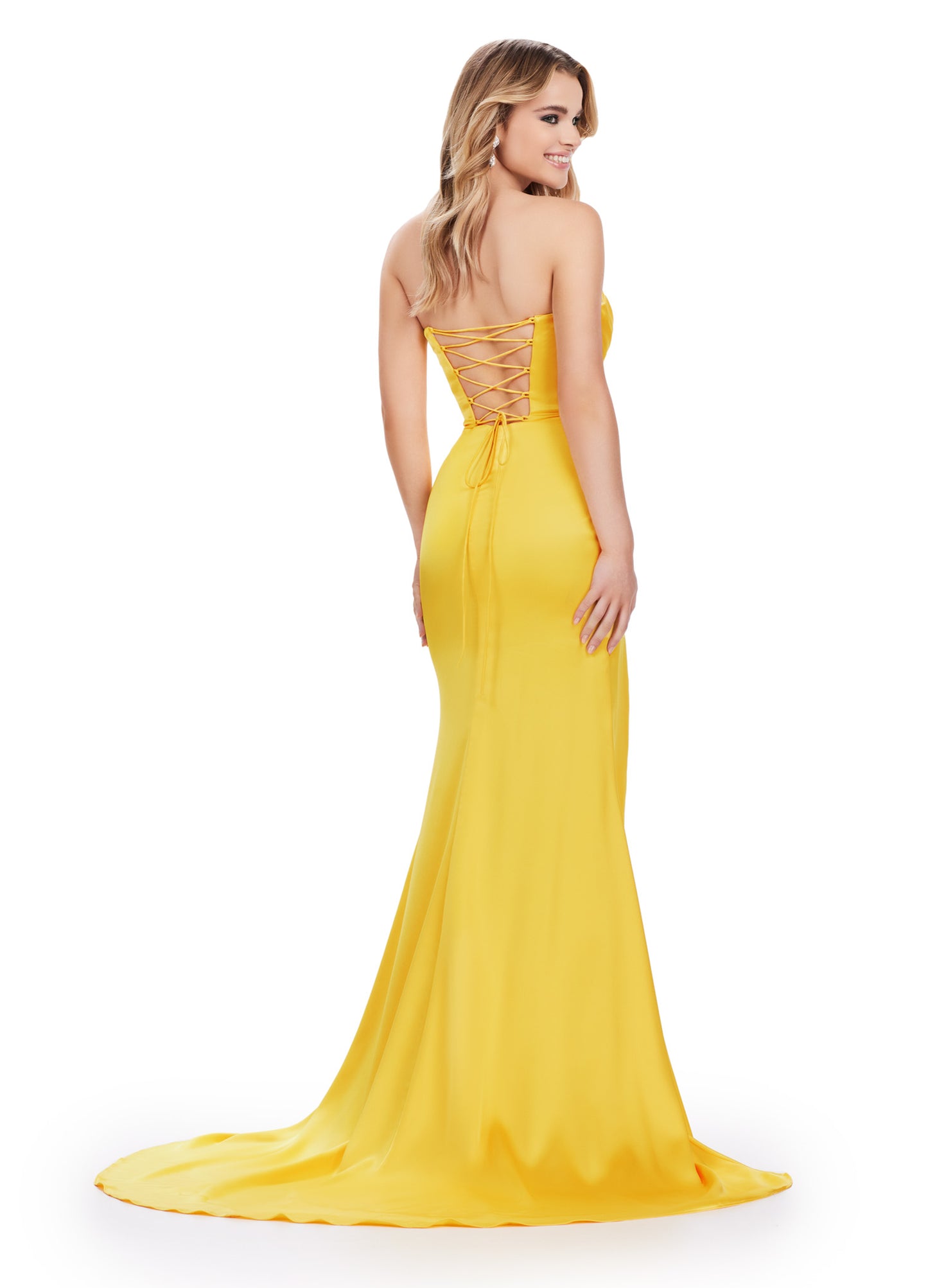 Get ready to make a statement in the Ashley Lauren 11605 Long Prom Dress. This stunning gown features a strapless sweetheart neckline and a satin material that will hug your curves in all the right places. The lace-up back and thigh-high slit add a touch of drama and sophistication. Stand out at your next formal event with this elegant and stylish prom dress. A timeless classic! This strapless satin dress features ruched detail throughout. The lace up back and right leg slit complete the look.
