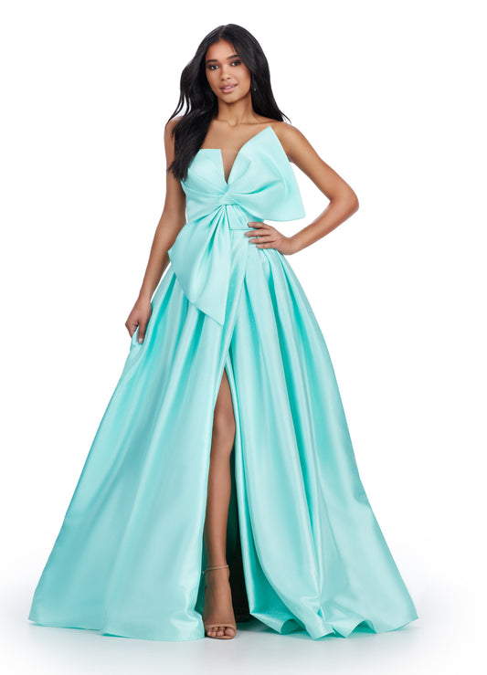 Discover the sophisticated elegance of the Ashley Lauren 11609 Long Prom Dress. Made with luxurious Mikado fabric, this strapless ball gown features an oversized bow for a dramatic touch. Perfect for formal events and pageants, this dress will make you feel like royalty with its timeless style and flattering silhouette. We love a bow moment! This strapless Mikado ball gown features an asymmetrical oversized bow with wrap skirt.