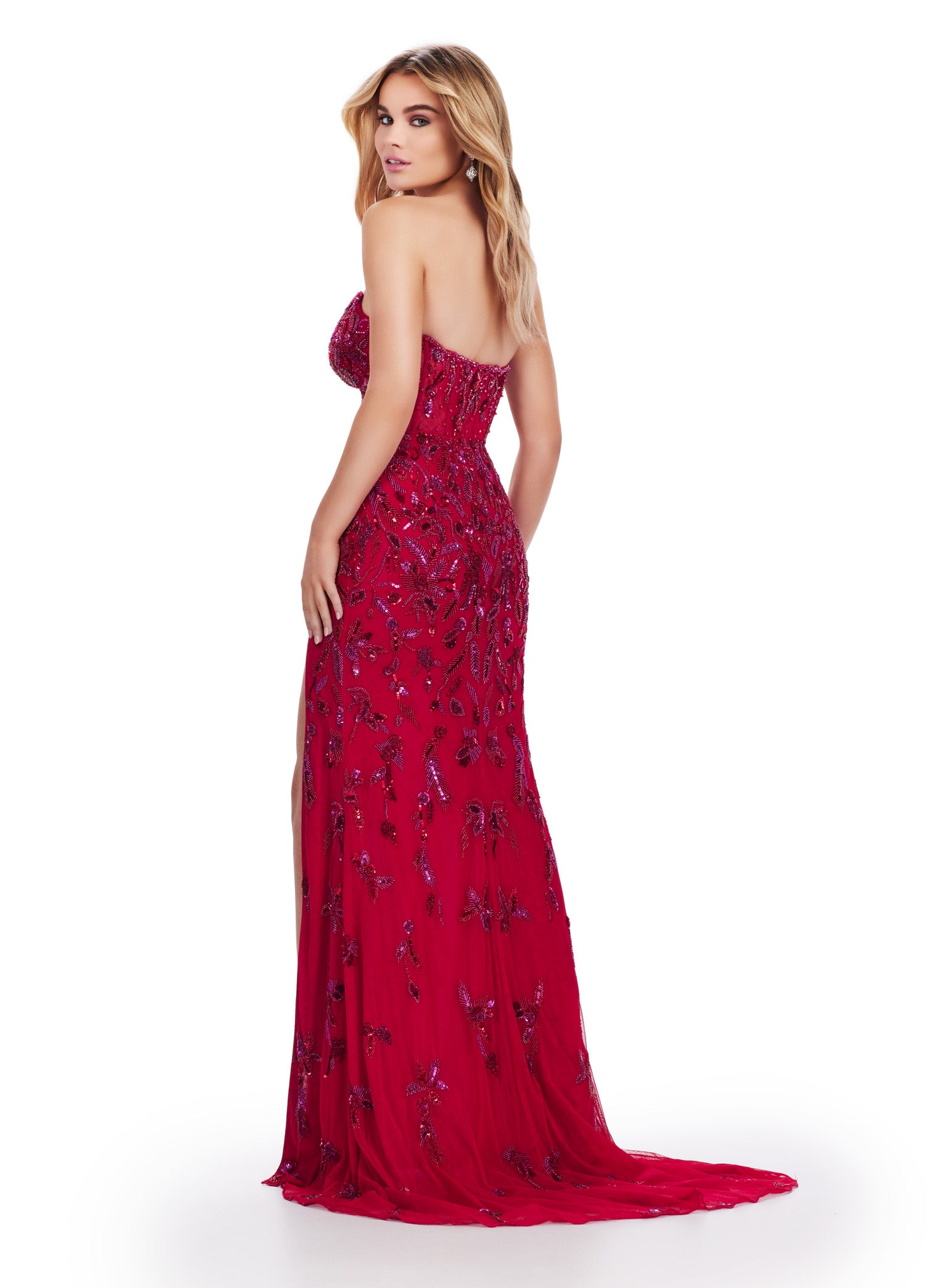 Achieve a stunning look with Ashley Lauren's 11614 Long Prom Dress. The beaded strapless gown features a corset bustier and a slit, adding a touch of elegance to its formal pageant style. Confidently stand out and make a statement at your special occasion. Feel like royalty in this elegant gown. This fully beaded design features an illusion corset bustier. The beading flows throughout the gown, which has a left leg slit.