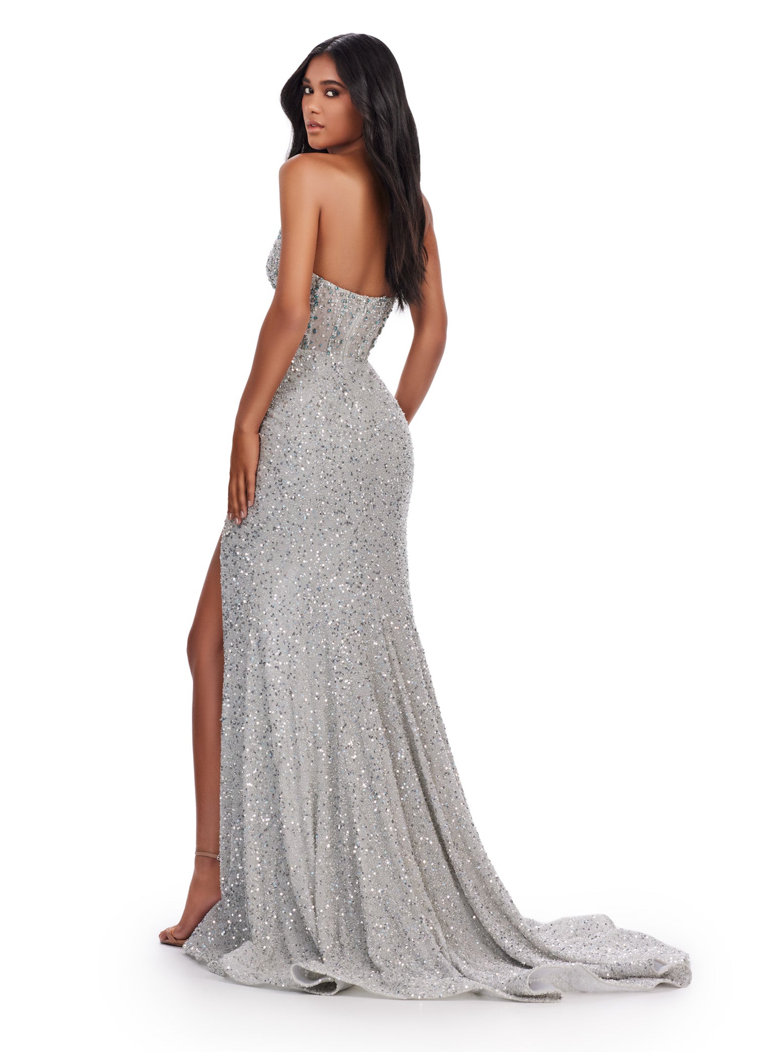 Elevate your formal look with the Ashley Lauren 11648 Long Prom Dress. Stunningly designed with a strapless, beaded corset bustier and a stylish slit, this gown exudes elegance and sophistication. Perfect for pageants and prom, it's sure to make a lasting impression. A fully beaded gown sure to make you feel like a queen! This dress features an illusion corset bustier and left leg slit.