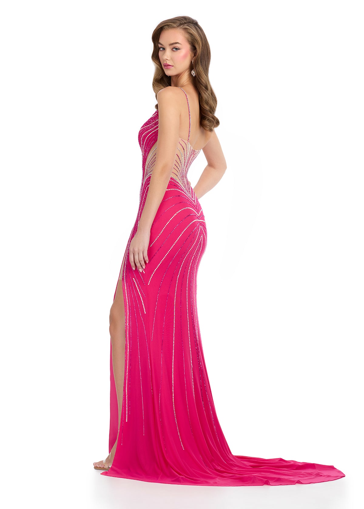 The Ashley Lauren 11902 Long Sheer Fitted Crystal Prom Dress is the epitome of elegance and glamour. With a slit v-neck design and intricate crystal embellishments, this dress is perfect for any formal occasion. Its fitted silhouette accentuates your curves, while the sheer material adds a touch of sexiness. Be the showstopper at your next prom or pageant in this stunning gown.&nbsp;Stand out in this press on stone gown. The illusion cut outs are perfectly placed to accentuate your curves. The look is finis