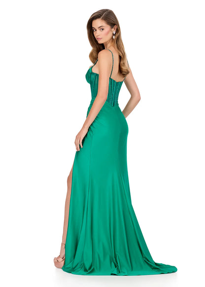 Step into sophistication with this sleek and elegant jersey gown, ASHLEYlauren Style 12173. Featuring a beaded bustier-style bodice with delicate spaghetti straps, this fitted dress highlights your figure with a ruched waist and flattering draped skirt. The corset detailing adds structure and sparkle, while the sweeping train ensures a glamorous finish. Perfect for prom, pageant, or any formal event, this gown brings modern allure and timeless elegance together.

Available in Emerald, Purple, Red, Black, Fu
