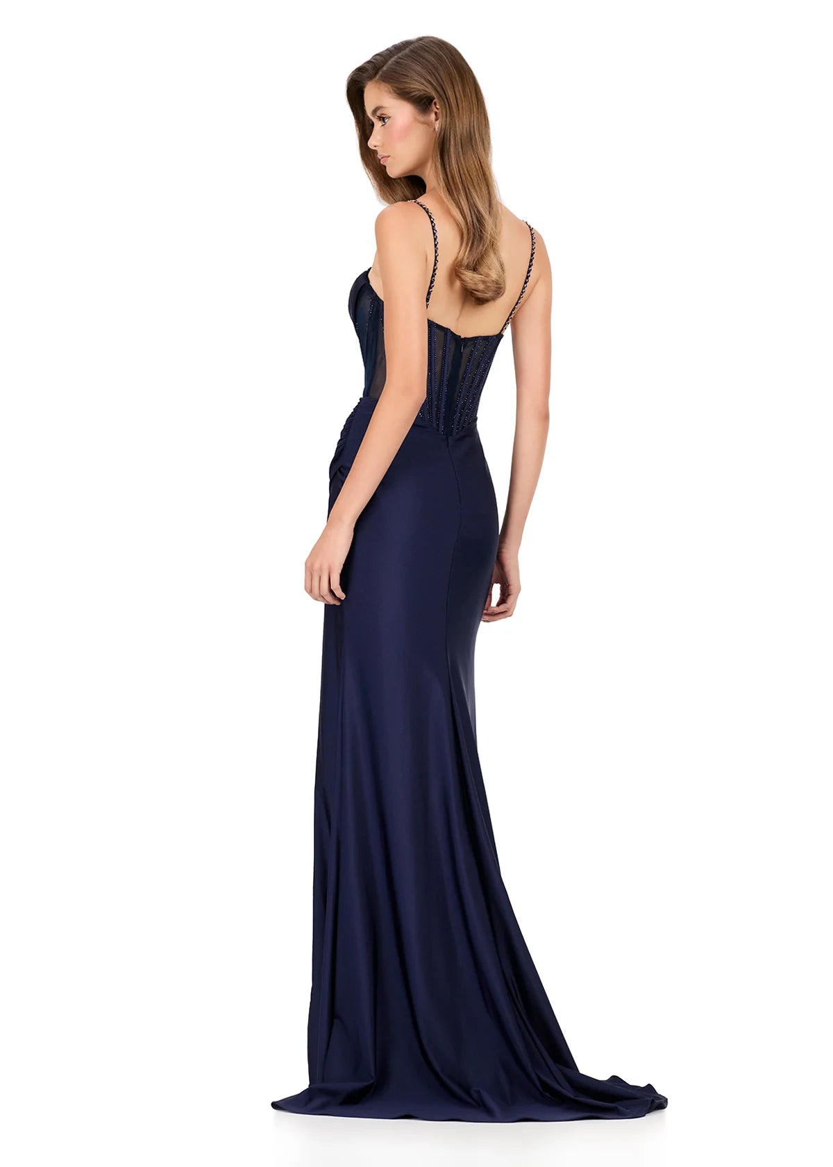 Step into sophistication with this sleek and elegant jersey gown, ASHLEYlauren Style 12173. Featuring a beaded bustier-style bodice with delicate spaghetti straps, this fitted dress highlights your figure with a ruched waist and flattering draped skirt. The corset detailing adds structure and sparkle, while the sweeping train ensures a glamorous finish. Perfect for prom, pageant, or any formal event, this gown brings modern allure and timeless elegance together.

Available in Emerald, Purple, Red, Black, Fu