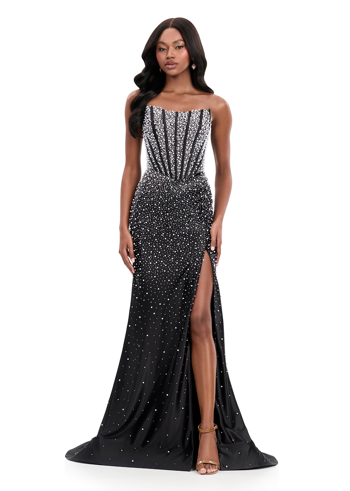 ASHLEYlauren Style 12356 is a fully beaded evening gown that commands attention with its fitted silhouette and strapless neckline.&nbsp; Ashley Lauren 12356 The expertly contoured bodice features vertical beadwork that accentuates the waist and elongates the figure, while a sweeping train with slit adds dramatic movement. Crafted from jersey fabric with pearl corset bustier detailing, this gown delivers high-impact sparkle from every angle. Ideal for pageants, red carpet events, prom, galas, and special occ