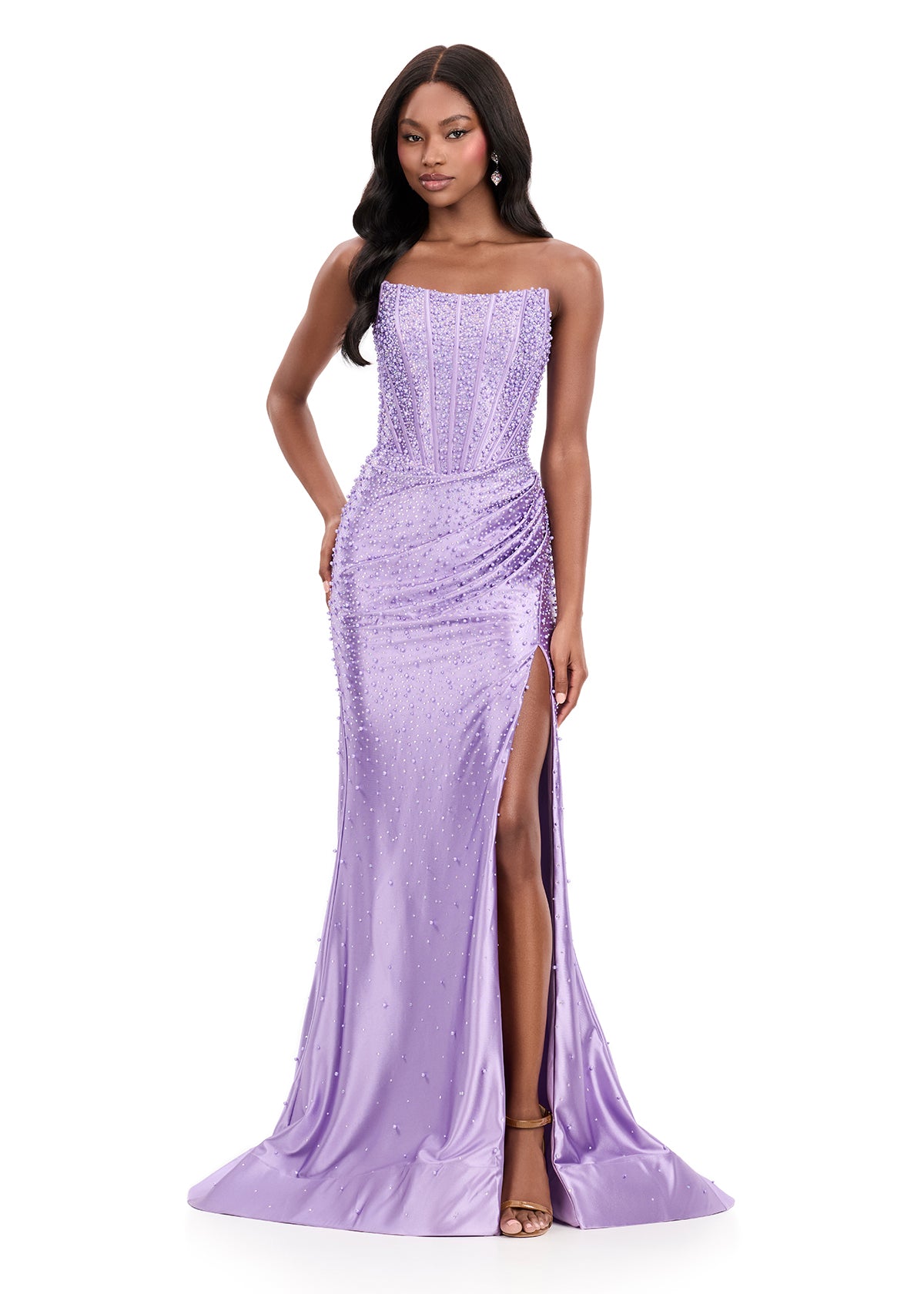 ASHLEYlauren Style 12356 is a fully beaded evening gown that commands attention with its fitted silhouette and strapless neckline.&nbsp; Ashley Lauren 12356 The expertly contoured bodice features vertical beadwork that accentuates the waist and elongates the figure, while a sweeping train with slit adds dramatic movement. Crafted from jersey fabric with pearl corset bustier detailing, this gown delivers high-impact sparkle from every angle. Ideal for pageants, red carpet events, prom, galas, and special occ