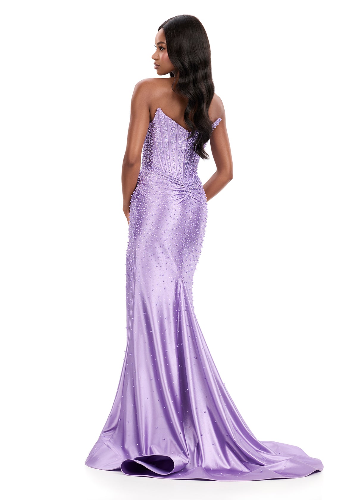 ASHLEYlauren Style 12356 is a fully beaded evening gown that commands attention with its fitted silhouette and strapless neckline.&nbsp; Ashley Lauren 12356 The expertly contoured bodice features vertical beadwork that accentuates the waist and elongates the figure, while a sweeping train with slit adds dramatic movement. Crafted from jersey fabric with pearl corset bustier detailing, this gown delivers high-impact sparkle from every angle. Ideal for pageants, red carpet events, prom, galas, and special occ