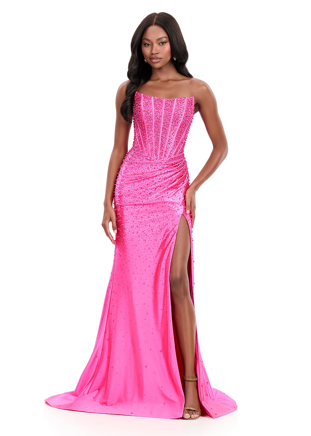 ASHLEYlauren Style 12356 is a fully beaded evening gown that commands attention with its fitted silhouette and strapless neckline.&nbsp; Ashley Lauren 12356 The expertly contoured bodice features vertical beadwork that accentuates the waist and elongates the figure, while a sweeping train with slit adds dramatic movement. Crafted from jersey fabric with pearl corset bustier detailing, this gown delivers high-impact sparkle from every angle. Ideal for pageants, red carpet events, prom, galas, and special occ