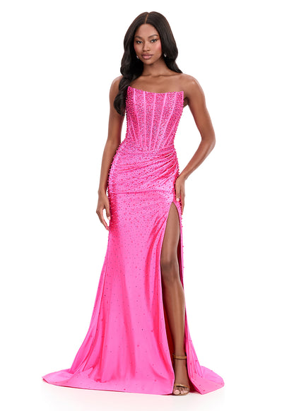ASHLEYlauren Style 12356 is a fully beaded evening gown that commands attention with its fitted silhouette and strapless neckline.&nbsp; Ashley Lauren 12356 The expertly contoured bodice features vertical beadwork that accentuates the waist and elongates the figure, while a sweeping train with slit adds dramatic movement. Crafted from jersey fabric with pearl corset bustier detailing, this gown delivers high-impact sparkle from every angle. Ideal for pageants, red carpet events, prom, galas, and special occ