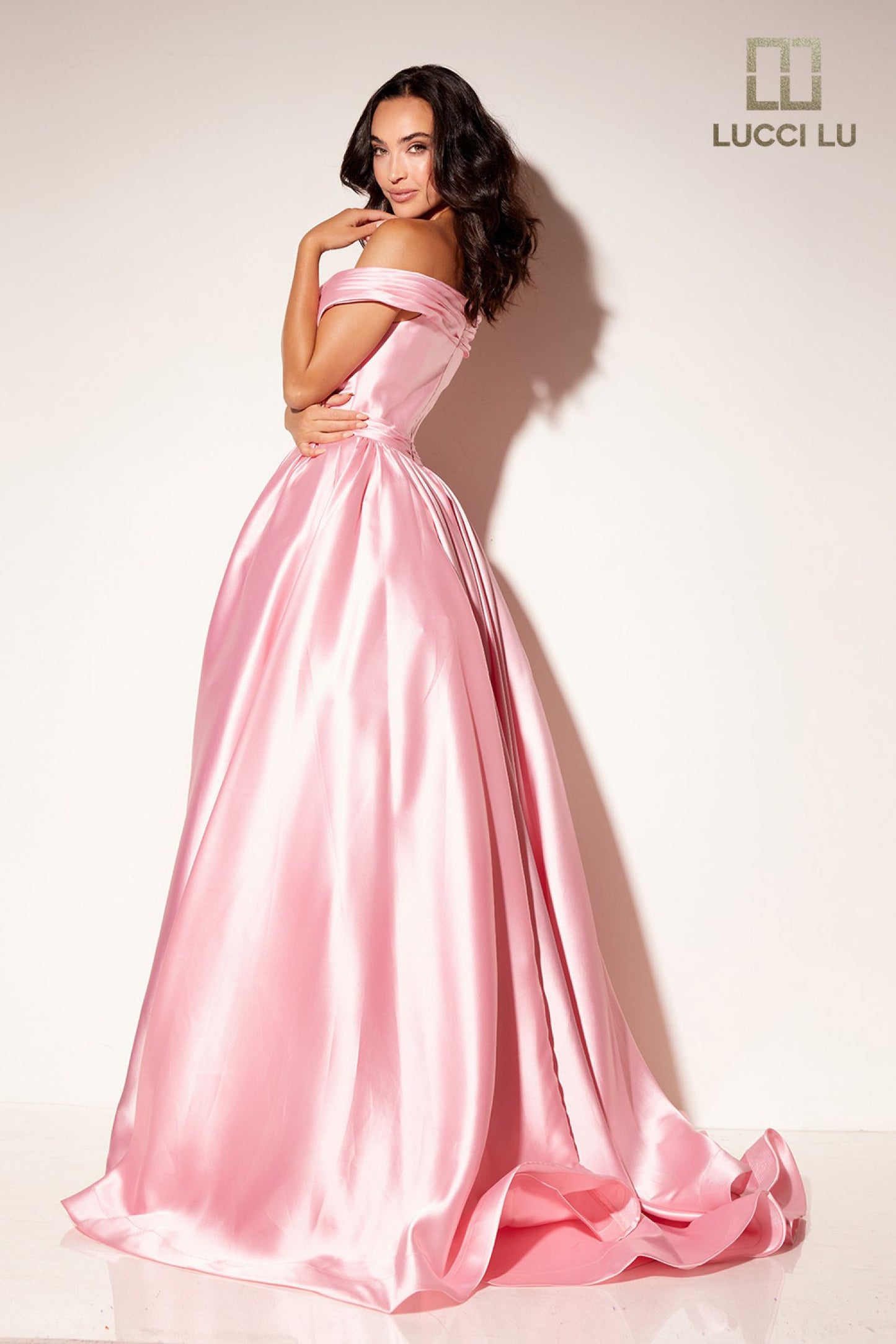 Be the belle of the ball in the Lucci Lu 1341 pink taffeta off the shoulder prom dress. The maxi length and slit offer sophisticated elegance, while the ruffle ballgown silhouette adds a touch of romance. Perfect for any evening event, this dress is sure to turn heads.