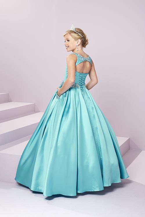 Expertly designed for the modern princess, the Tiffany Princess 13485 Girls Pageant Dress is a stunning Mikado A Line masterpiece. Embellished with intricate beadwork and featuring convenient pockets, this open back ball gown will make any young lady feel like royalty. <span data-mce-fragment="1">A beaded scoop neckline and waistband showcase this adorable gown. Complete with a box pleated, a-line mikado skirt with front Pockets, and an open back with lace-up.</span>