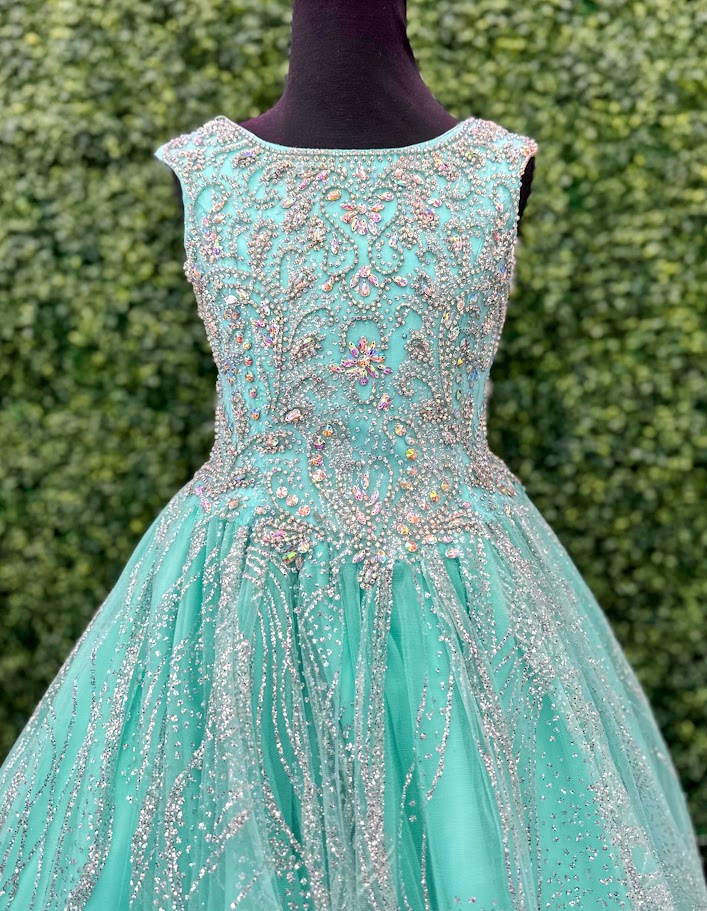 <p data-mce-fragment="1">The Tiffany Princess 13575 Pageant Dress is the epitome of elegance. Featuring a high neck and crystal embellishments, this A-line gown exudes sophistication and grace. Made with sparkling glitter and quality materials, it will make any young girl feel like royalty. Perfect for pageants or any formal event.&nbsp;</p> <p data-mce-fragment="1">Sizes: 2-16</p> <p data-mce-fragment="1">Colors: Aqua, Lilac, White</p>
