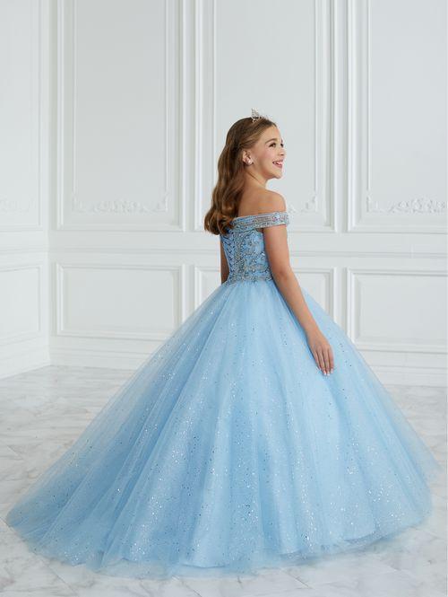 This Tiffany Princess pageant dress Style 13677 features a stunning A-line design with intricate beading and glitter details. The tulle ball gown is completed with delicate off the shoulder neckline accented by bows for added elegance. Perfect for formal events, this dress will make your little girl feel like a princess. Corset Back