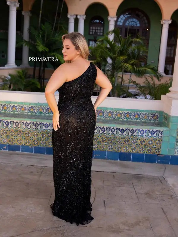 Make a statement in Primavera Couture's 14047 Plus Size Sequin Prom Dress. Designed to hug your curves, this dress features an asymmetrical one shoulder neckline, Sequins, beading and fringe detail. For a glamorous look, pair it with strappy heels and a small clutch.  Sizes: 14W-24W  Colors: Black, Fuchsia, Platinum 