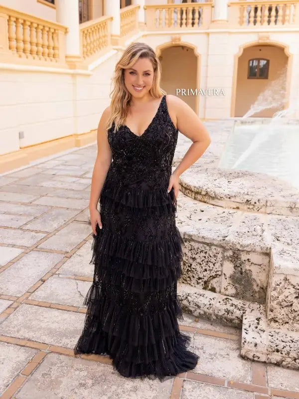 This elegant Primavera Couture 14052 prom dress is designed to showcase your curves with its long, fitted silhouette. The sequin detailing adds a touch of glamour, while the tiered skirt adds movement and volume. Perfect for formal occasions, this plus size gown is sure to turn heads.