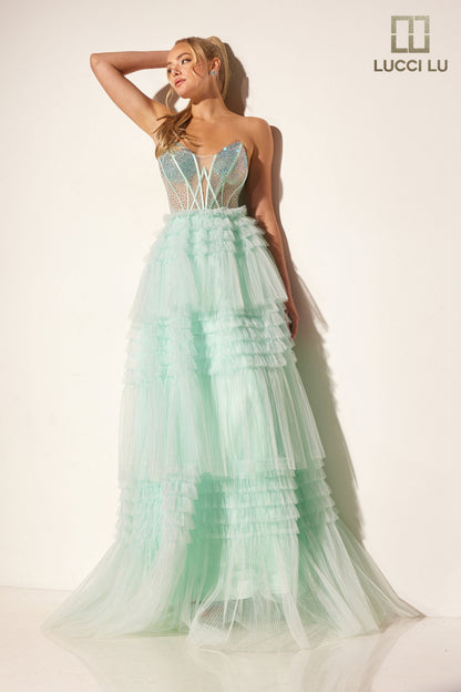 Stay elegant with the Lucci Lu 1408 Sheer Crystal Corset A Line Pleated Ruffle Prom Dress Layer Formal Ballgown. The strapless design enhances femininity while the sheer crystal corset adds a touch of glamour. The pleated ruffle and A-line silhouette create a flattering look for any formal event.

Sizes: 00-12

Colors: Lilac, Mint