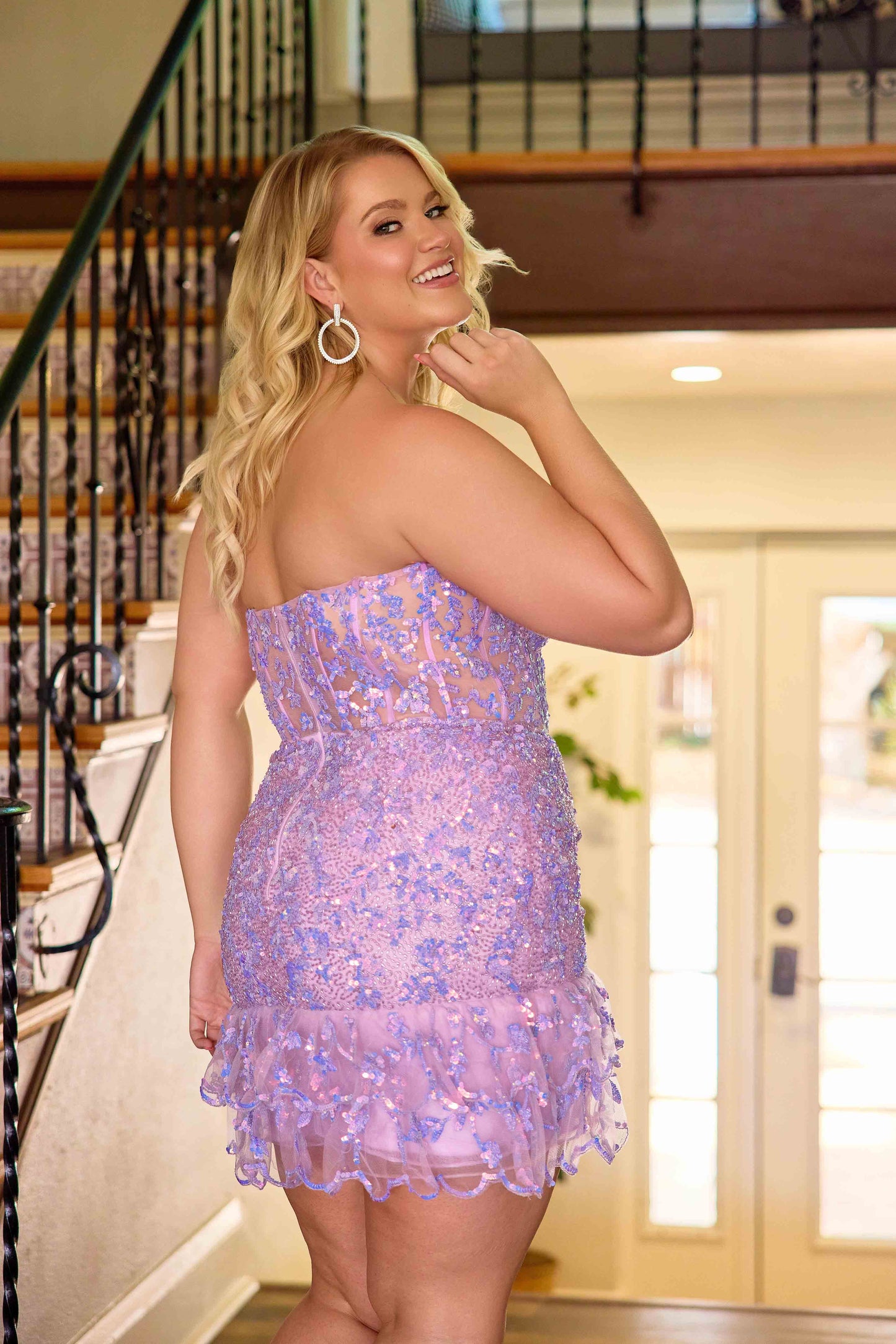 The Primavera Couture 14089 Plus Size Homecoming Dress combines sophisticated design with flattering fit. Featuring a sequin-embellished bodice and a delicate ruffle hem, this gown accentuates curves elegantly. The sheer corset detail adds a modern touch while providing structured support, making it an ideal choice for formal events and cocktail parties. Crafted to enhance confidence and style, this dress offers a stunning silhouette for any plus-size wearer seeking both glamour and comfort.

Sizes: 14W-24W