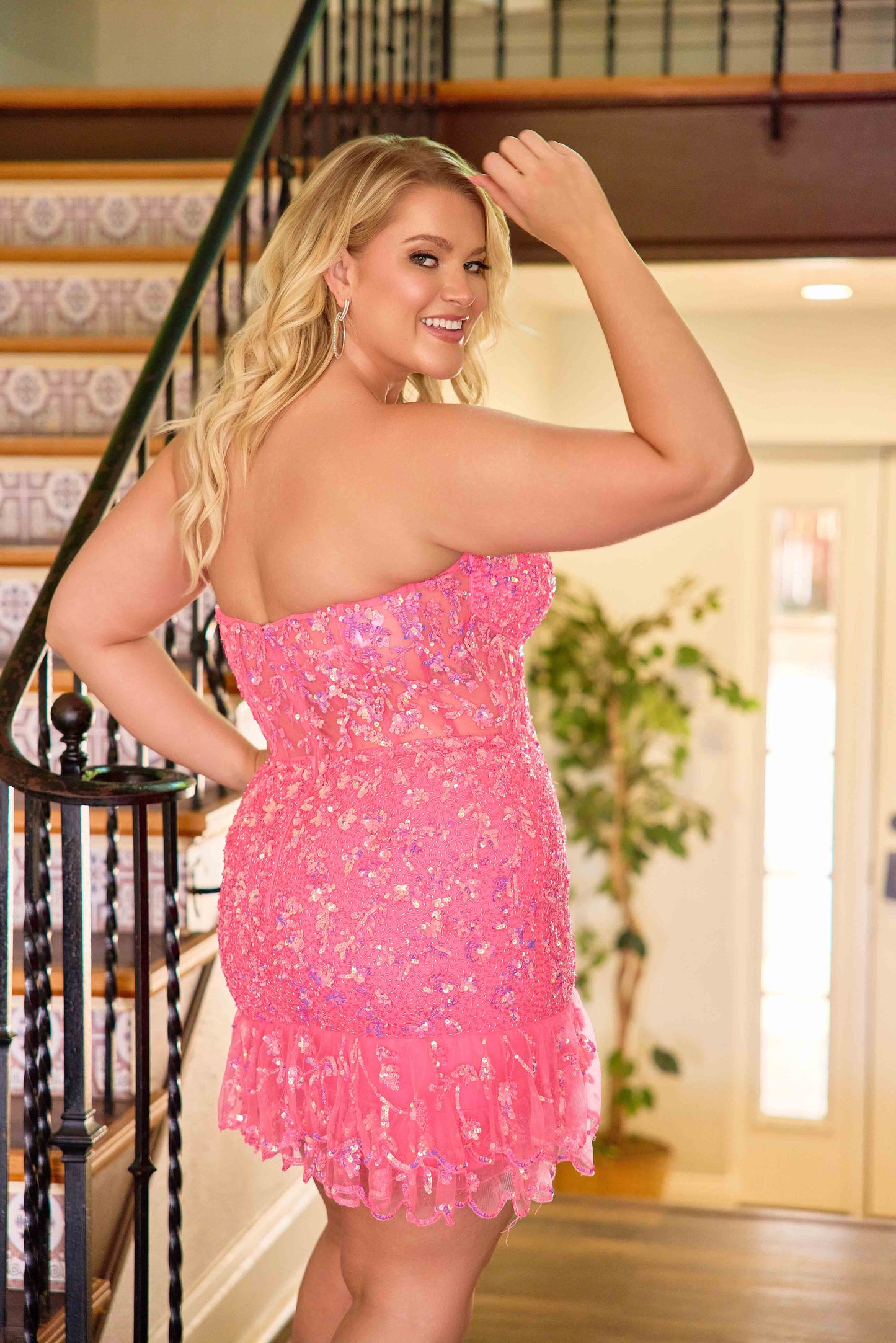 The Primavera Couture 14089 Plus Size Homecoming Dress combines sophisticated design with flattering fit. Featuring a sequin-embellished bodice and a delicate ruffle hem, this gown accentuates curves elegantly. The sheer corset detail adds a modern touch while providing structured support, making it an ideal choice for formal events and cocktail parties. Crafted to enhance confidence and style, this dress offers a stunning silhouette for any plus-size wearer seeking both glamour and comfort.

Sizes: 14W-24W