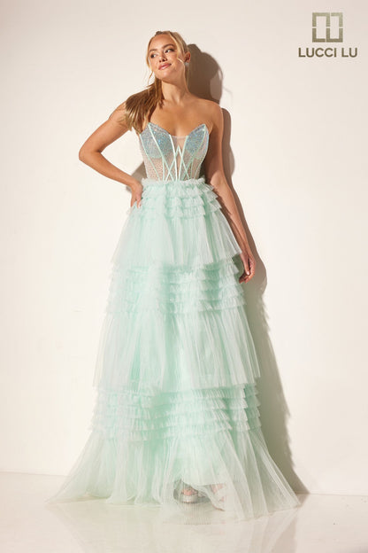 Stay elegant with the Lucci Lu 1408 Sheer Crystal Corset A Line Pleated Ruffle Prom Dress Layer Formal Ballgown. The strapless design enhances femininity while the sheer crystal corset adds a touch of glamour. The pleated ruffle and A-line silhouette create a flattering look for any formal event.

Sizes: 00-12

Colors: Lilac, Mint