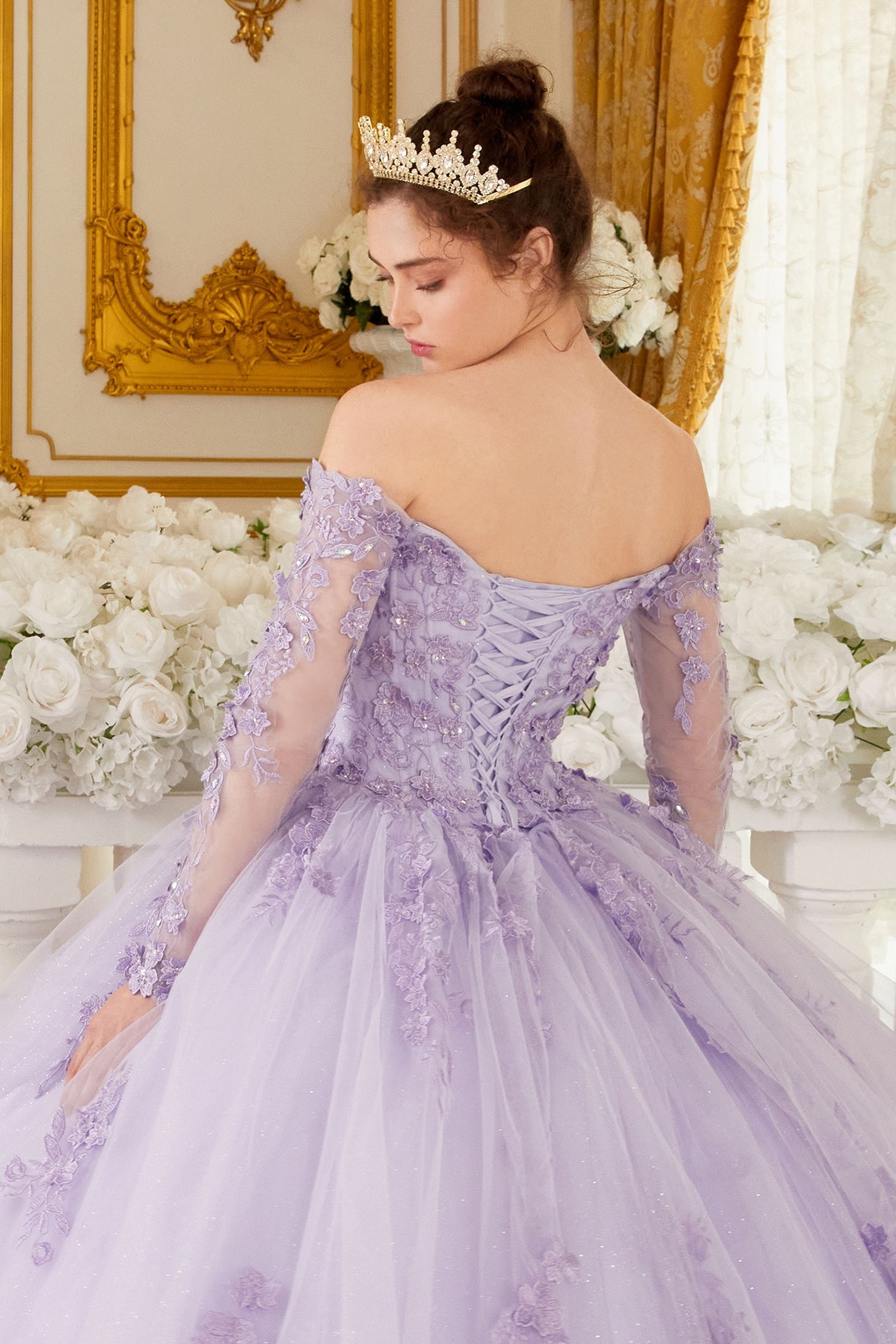 This Ladivine 15706 dress will have you feeling like royalty! The off-the-shoulder style and lacy corset make it perfect for your quinceanera or special event. Get ready for the night of a lifetime in this absolutely stunning ballgown! Imagine looking like royalty on your special day. This gorgeous off-the-shoulder, long-sleeved ball gown is an enchanting piece of work that will make you look like a quinceanera princess! The crafted lace and beaded applique add the perfect amount of shine to the bodice. 