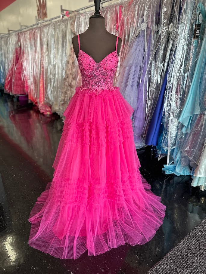 Elevate your formal occasion with the Nina Canacci 1582 ballgown in vibrant fuchsia. This size 4 gown features a sheer lace corset that beautifully contours the silhouette, complemented by delicate pleated ruffles cascading into an elegant A-line skirt. Designed for timeless sophistication, it offers a graceful blend of structure and softness, perfect for making a memorable entrance at prom or any special event.

Size: 4

Color: Fuchsia