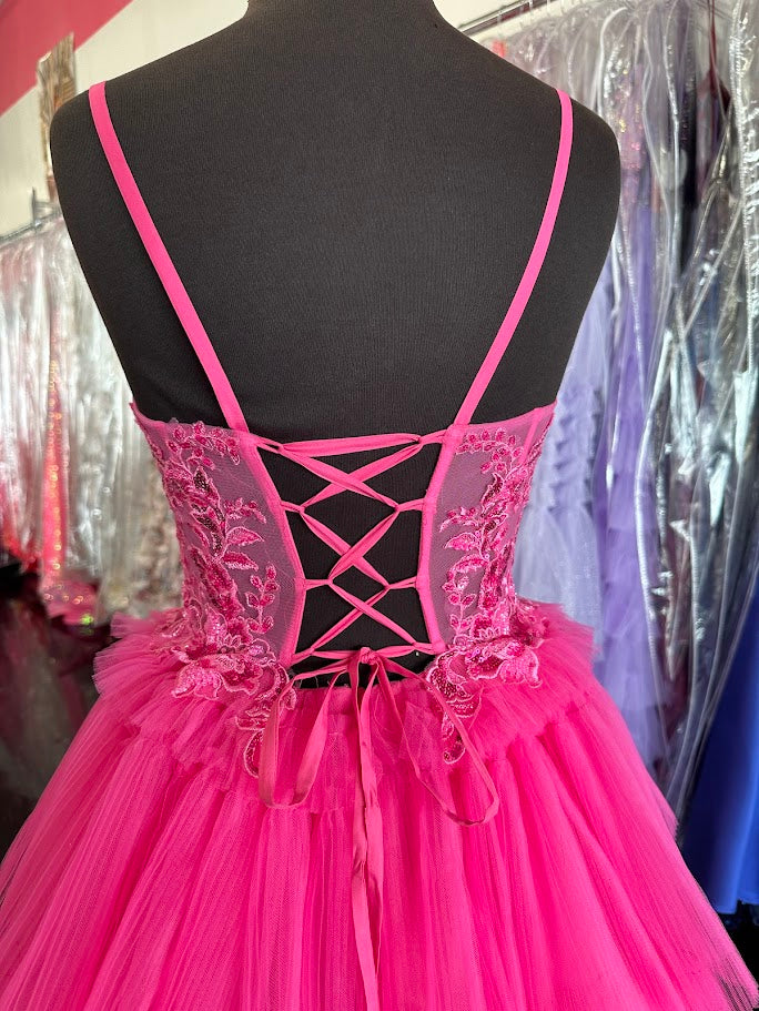 Elevate your formal occasion with the Nina Canacci 1582 ballgown in vibrant fuchsia. This size 4 gown features a sheer lace corset that beautifully contours the silhouette, complemented by delicate pleated ruffles cascading into an elegant A-line skirt. Designed for timeless sophistication, it offers a graceful blend of structure and softness, perfect for making a memorable entrance at prom or any special event.

Size: 4

Color: Fuchsia