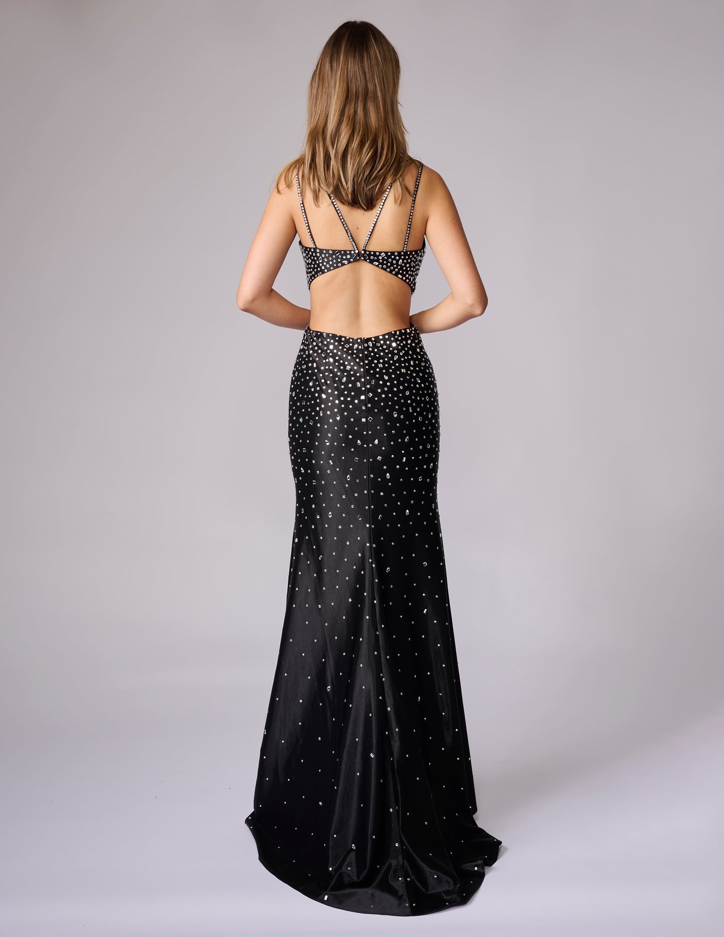 This Nina Canacci design showcases masterful construction with its signature cut glass mirror embellishments that deliver exceptional light refraction and visual depth. The mermaid silhouette provides a refined fit through the bodice and hips, transitioning into a graceful sweep. The backless cut demonstrates confident design, offering both architectural interest and modern elegance. Crafted for discerning customers who appreciate quality craftsmanship and timeless formal wear that commands attention.

Size