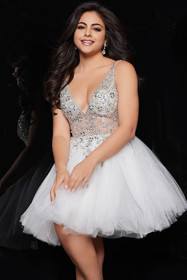 Jovani 1774 Tulle Sheer V-Neck Embellished Bodice Short Cocktail Homecoming Dress. Make a statement at your event with the Jovani 1774 White Fit and Flare Tulle Homecoming Dress. This stunning dress features a fitted bodice with intricate beading and a flared tulle skirt, creating a breathtaking and eye-catching silhouette. With its elegant design and high-quality construction, this dress will make you the center of attention on any special occasion.