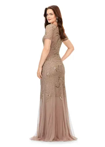 Ashley Lauren 11215 Illusion Sweetheart Neckline Beaded Mermaid Silhouette Short Sleeve Evening. Dazzle in this illusion sweatheart neckline gown. The inticate sequin motifs flows throughout the neckline, sleeves and down the gown. The skirt is finished with godets to create the perfect silhouette.