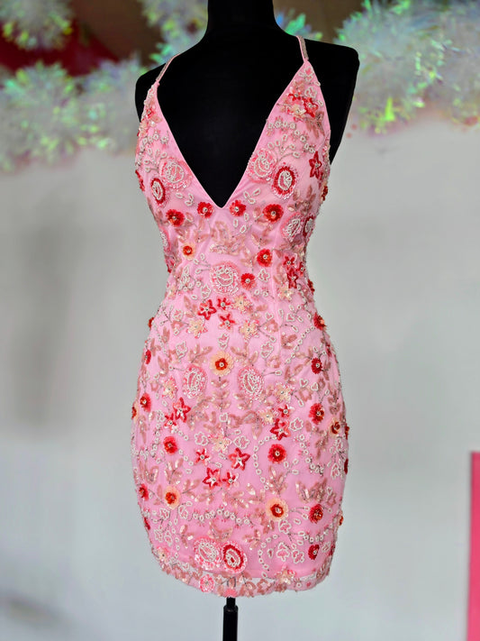 Primavera Couture 1938 Make a statement in this beaded sequin short homecoming dress with beaded 3D floral pattern v neckline and crisscross spaghetti straps in the open back.&nbsp;

COLORS: Pink

Sizes:&nbsp; 2
