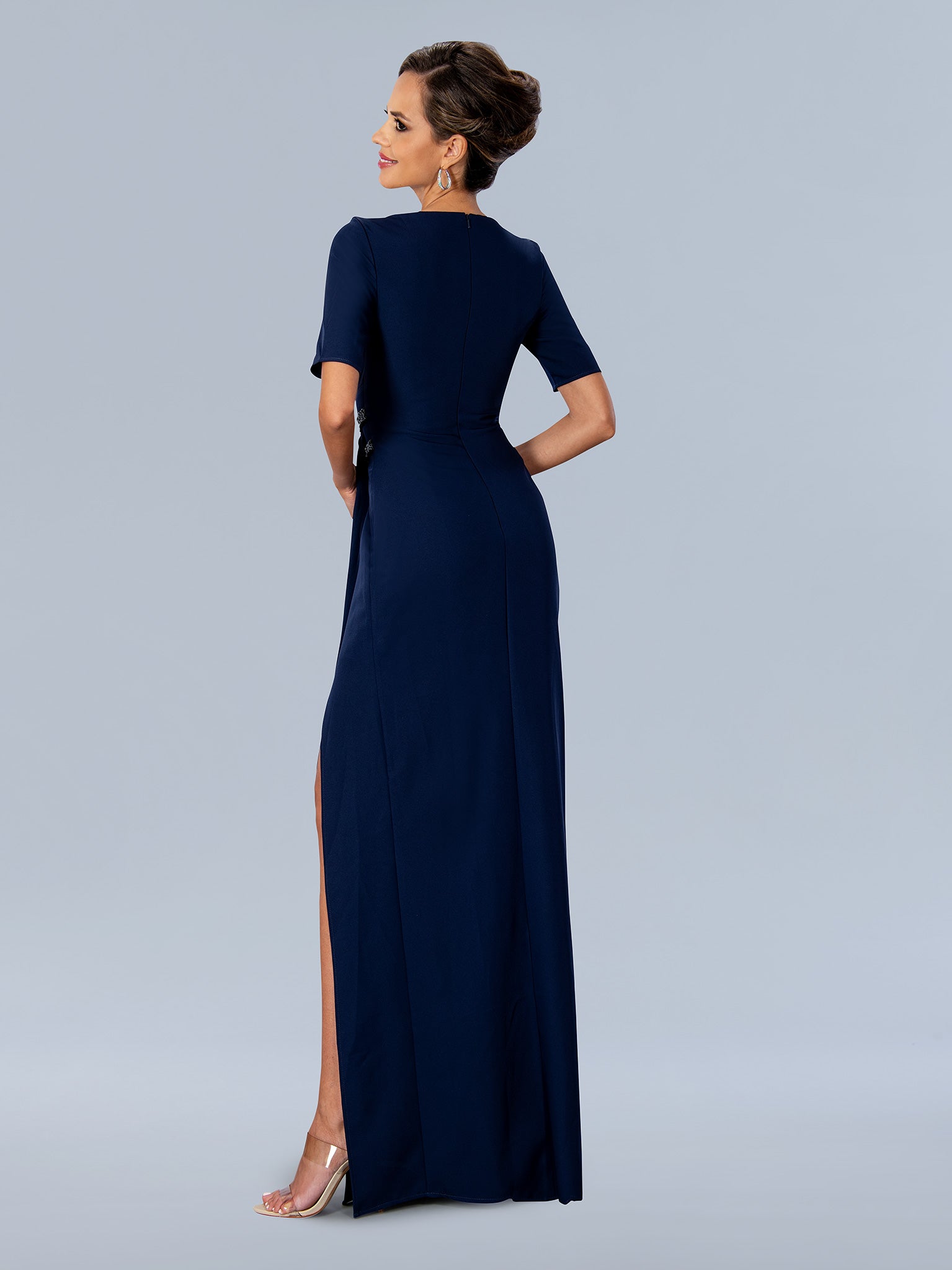 Elevate your special occasion look with the Stella Couture 24317 navy formal gown, designed in size 10 for a refined fit. This mother-of-the-bride dress features elegant short sleeves and sophisticated ruching that flatters your silhouette. A tasteful slit adds a modern touch, ensuring ease of movement while maintaining formal elegance. Crafted with attention to detail, this gown combines comfort and style for a polished and confident appearance at any event.

Size: 10

Color: Navy