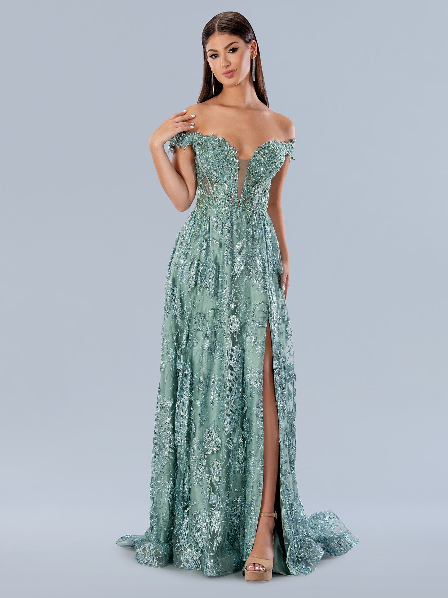 Stella Couture 21064 is a long a line formal prom and pageant dress. Featuring a plunging deep V Neckline with a sheer embellished bodice and off the shoulder straps. high slit in skirt. lace up corset back. Great for any formal event.  Available Size: 0-18  Available Color: Green, Blue, Sage, Royal