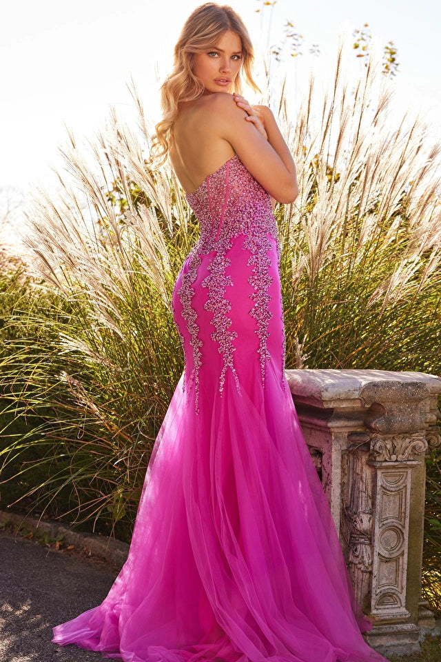 Jovani 22538 Beaded Corset Bodice Tulle Fit And Flare Bottom Prom Dress. This gorgeous dress features a form-fitting fit and flare silhouette, a floor-length skirt with a godet bottom and high side slit, and a strapless sweetheart neckline. The sheer corset bodice is adorned with delicate beading and boning, adding structure and sparkle to this show-stopping dres
