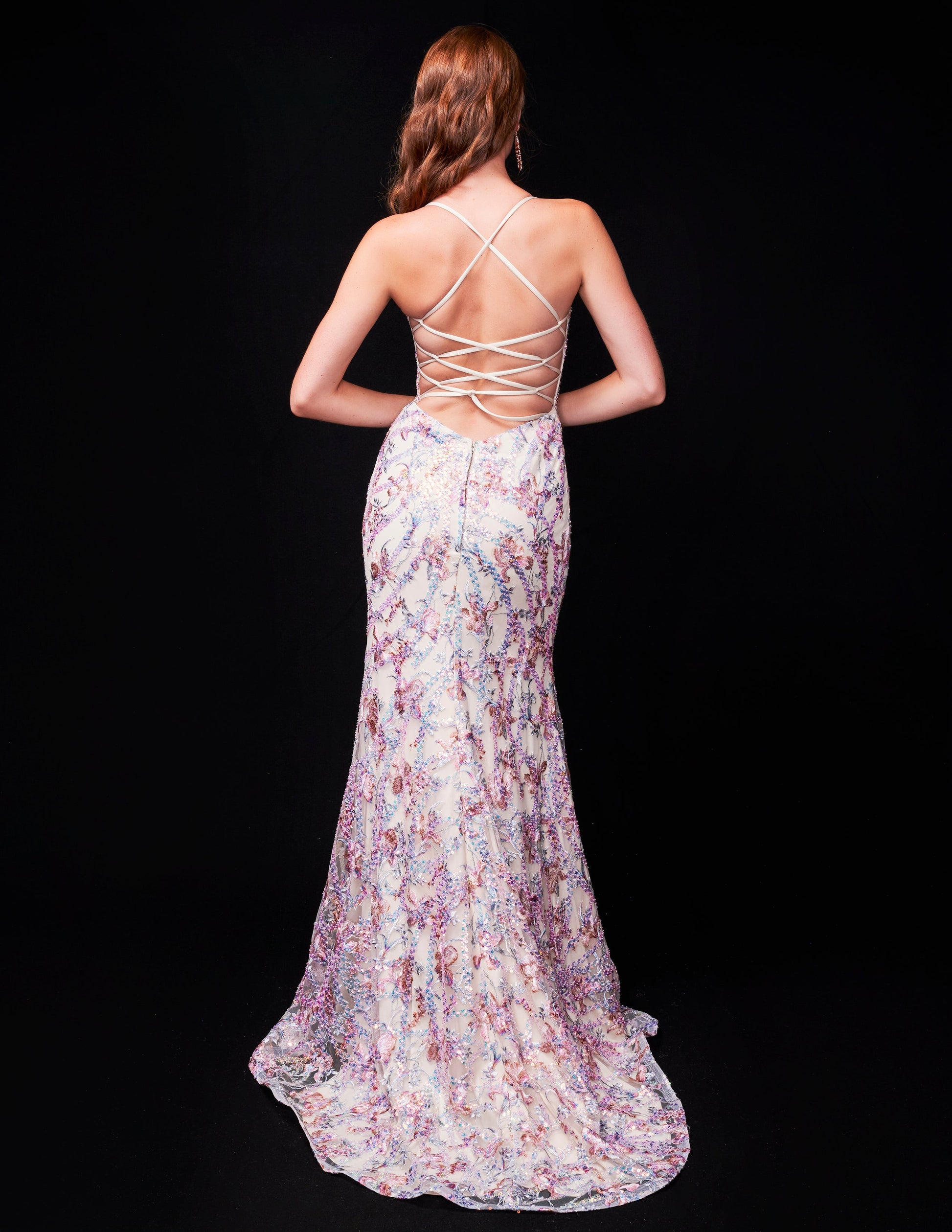 This Nina Canacci 2372 formal dress features intricate beading, a backless corset design, and a sequin-adorned gown with a V-neck and thigh-high slit. Show off your figure in this fitted dress, perfect for any formal occasion.