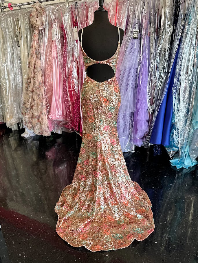 Be the star of the evening in the Nina Canacci 2393 Sequin Floral Prom Dress. This stunning gown features a beautiful floral sequin design, a flattering backless style, and a fitted V neck silhouette. Perfect for formal events or as a guest, this dress will have all eyes on you.

Sizes: 4, 8

Colors: Gold/Multi