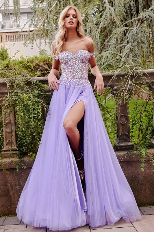 Jovani 23963 Lilac Multi Beaded Bodice Gown is a stunning and unique dress designed for events. The gown features a fully beaded bodice in a variety of colors that add a touch of sophistication to the overall look. The dress is made with tulle fabric that gives it a light and airy feel. The off-the-shoulder neckline adds a touch of glamour, while the high slit allows for ease of movement. This gown is perfect for those who want to make a statement on their special night.