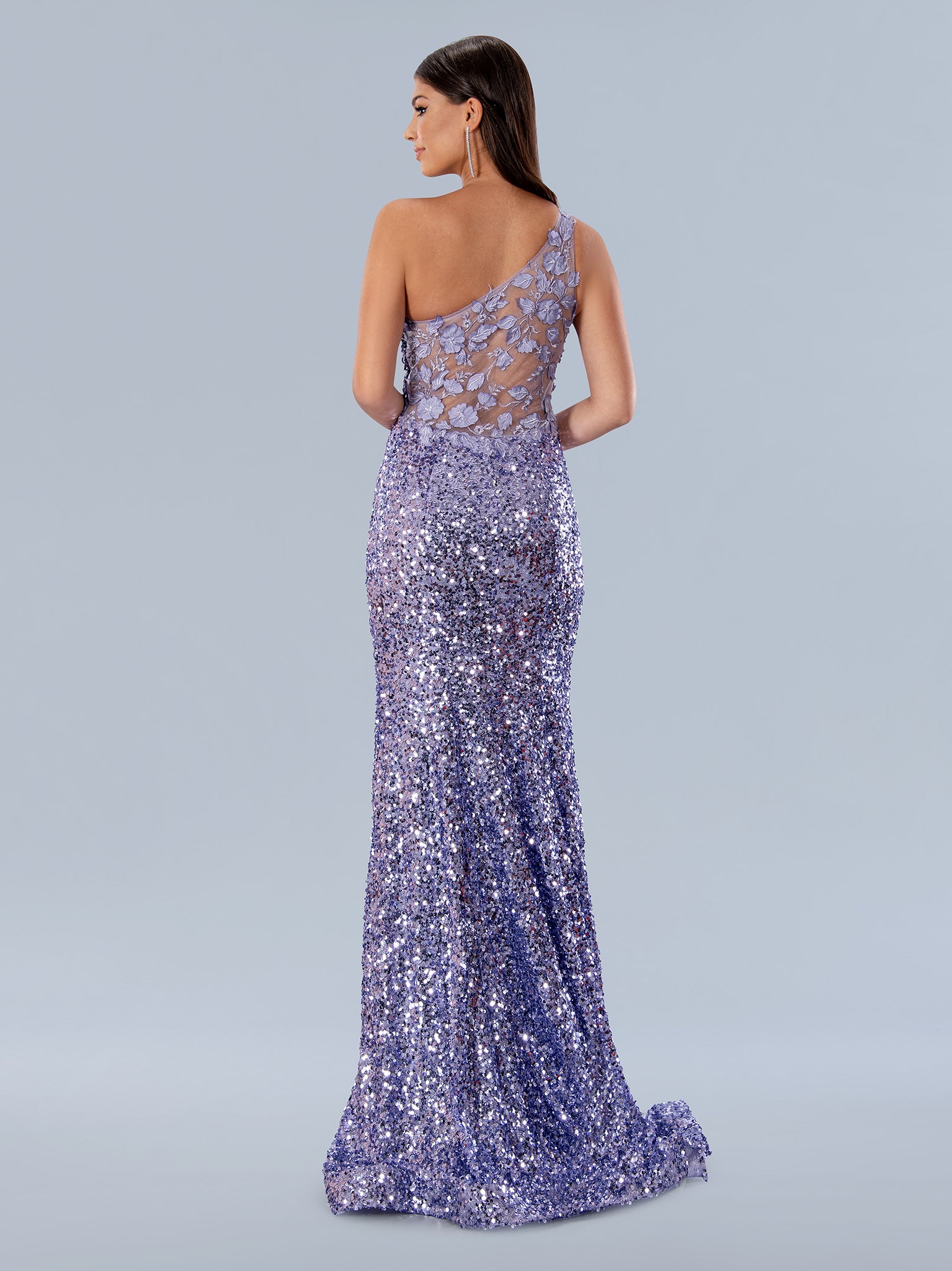 Stella Couture 24155 is a stunning One Shoulder Sequin Lace Prom Dress with a Sheer Back and 3d floral lace appliques. This elegant formal gown will make the perfect statement and turn heads at your special event.  Sizes: 0-16  Colors: Lilac