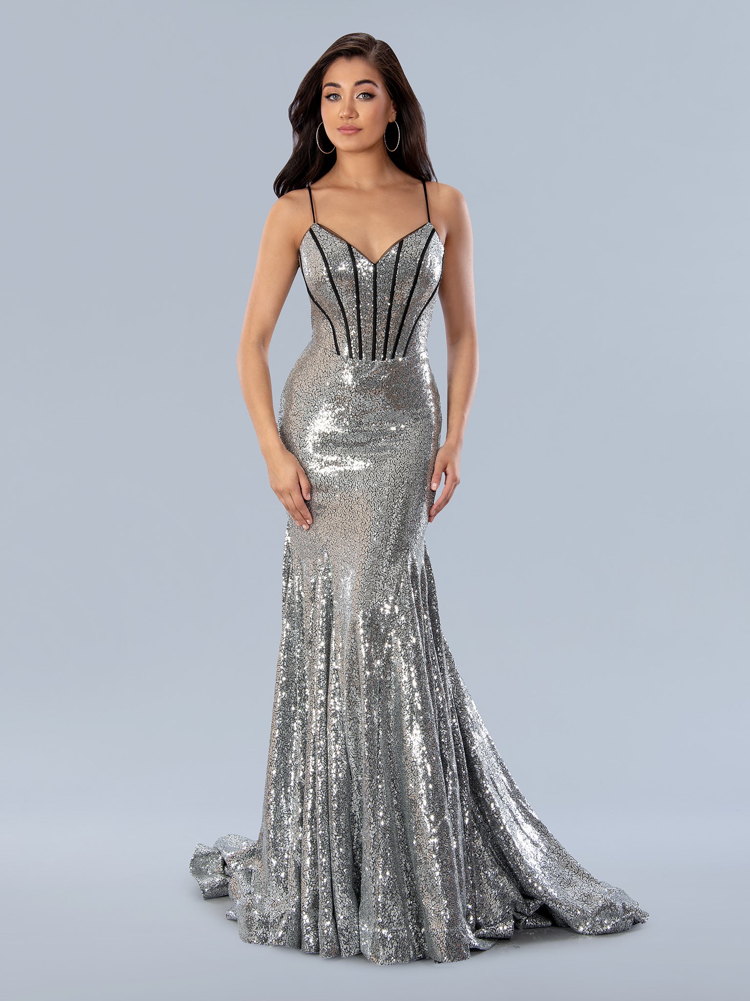 The Stella Couture 24202 Long Sequined Mermaid Gown is perfect for any formal event. Made of sparkling sequins, its mermaid silhouette flatters the figure, while its V-neck and corset closure enhance the fit.  Sizes: 0-16  Colors: Silver