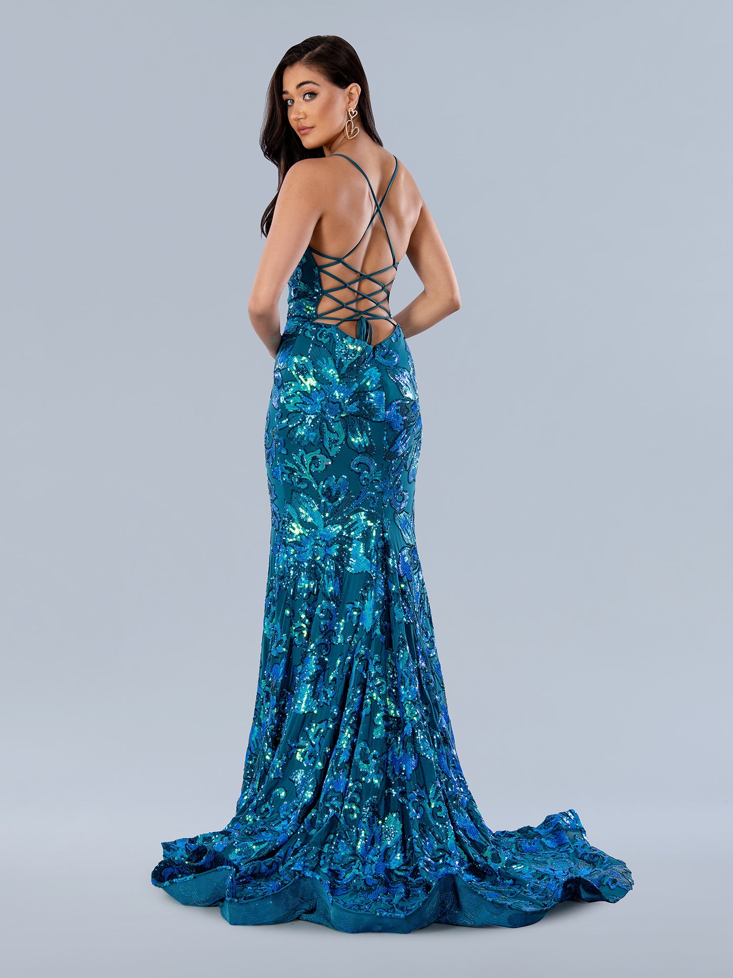 Look stunning in this Stella Couture 24239 Sequin Floral Fitted Mermaid Backless Prom Dress featuring a figure-hugging corset bodice and a beautiful mermaid skirt with sparkling sequins and floral details. The backless design and V-neckline add an elegant touch to this perfect garment for any special event.  Sizes: Blue  Colors: 0-16