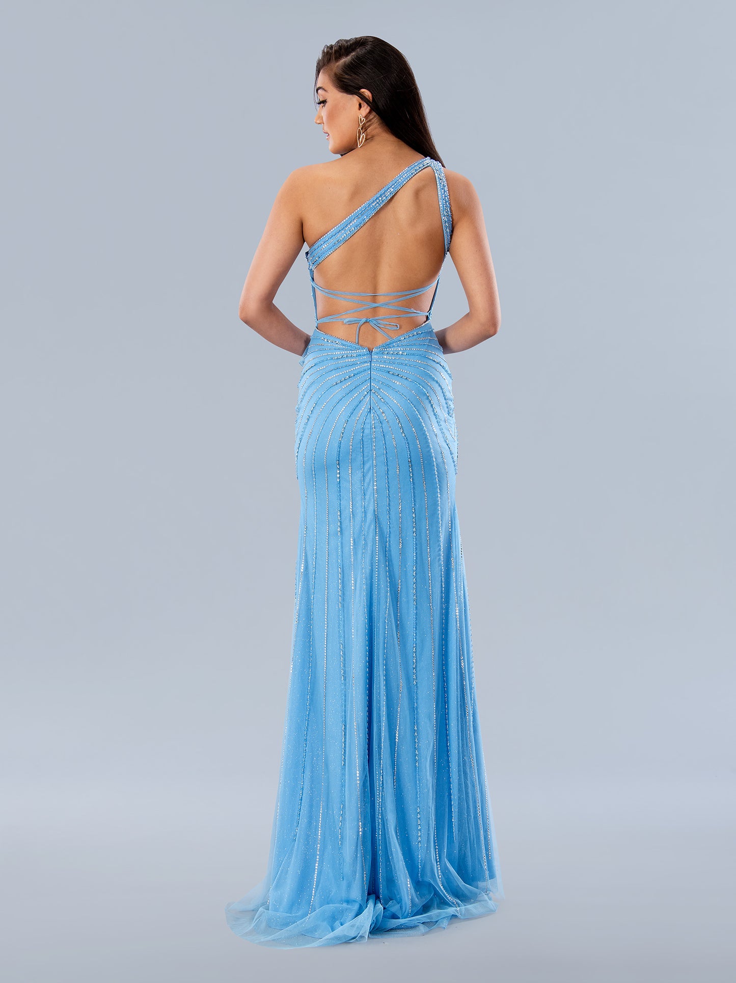 Stella Couture's 24246 Beaded One Shoulder Dress exudes timeless elegance with a modern twist. This sophisticatedly designed item features a ruffle waistline slit, an asymmetrically beaded single shoulder, a low-scooped back with corset supports, and a graceful side slit. The perfect pick for formals and proms.  Sizes: 0-16  Colors: Black, Blue