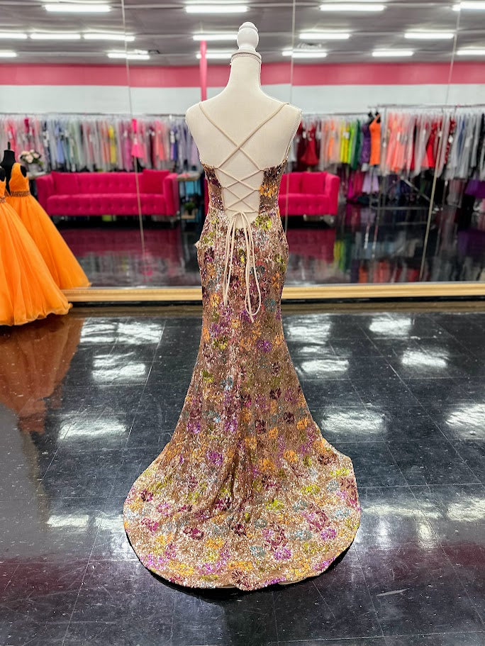 Elevate your evening with the Nina Canacci 2428, a size 4 fitted prom dress that exudes elegance. This gold gown features intricate floral sequins, a flattering scoop neckline, and a daring backless corset design. The thigh-high slit adds a touch of allure, making it perfect for unforgettable formal occasions.

Size: 4

Color: Gold