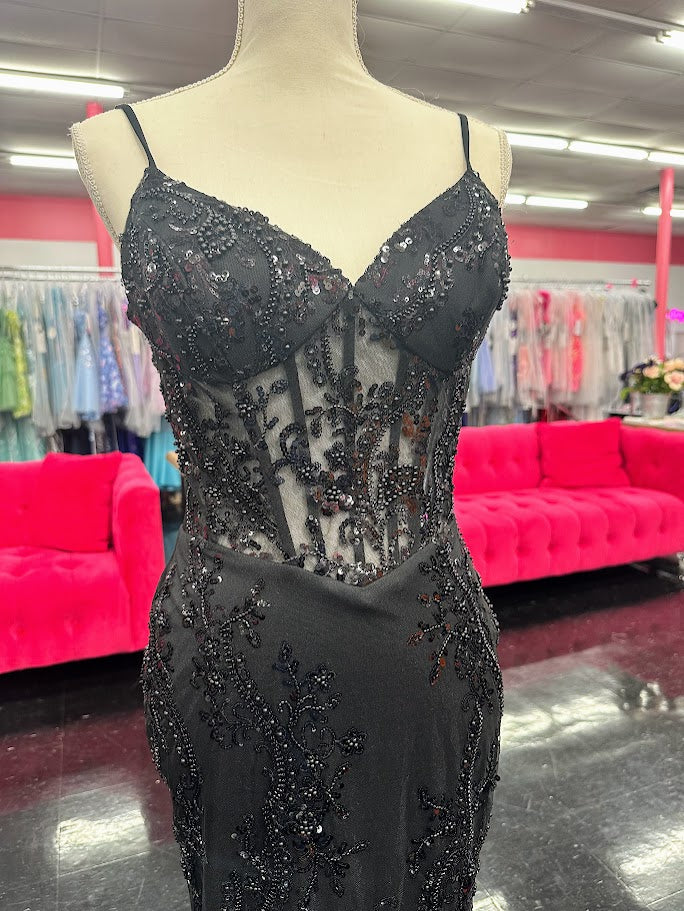 Elevate your evening with the Nina Canacci 2437, a size 4 black mermaid gown featuring intricate beading and a sheer corset design. This sophisticated prom dress contours your silhouette gracefully, combining elegance with a modern edge for unforgettable formal occasions.

Size: 4

Color: Black