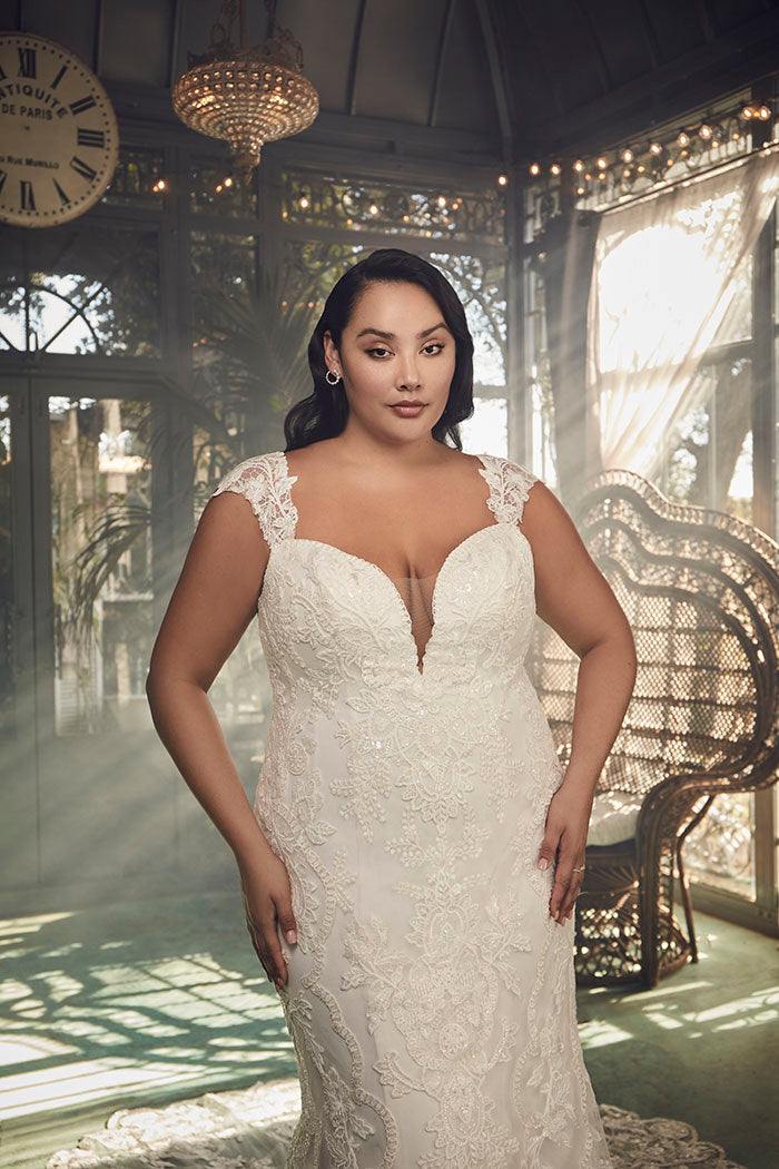 A portrait of timeless beauty, Justine Style 2485 by Casablanca Bridal is a vision of romanticism and femininity. Crafted from exquisite stretch chiffon, this figure-loving fit and flare silhouette features a plunging neckline and wide straps that frame a low-cut laced back. 
